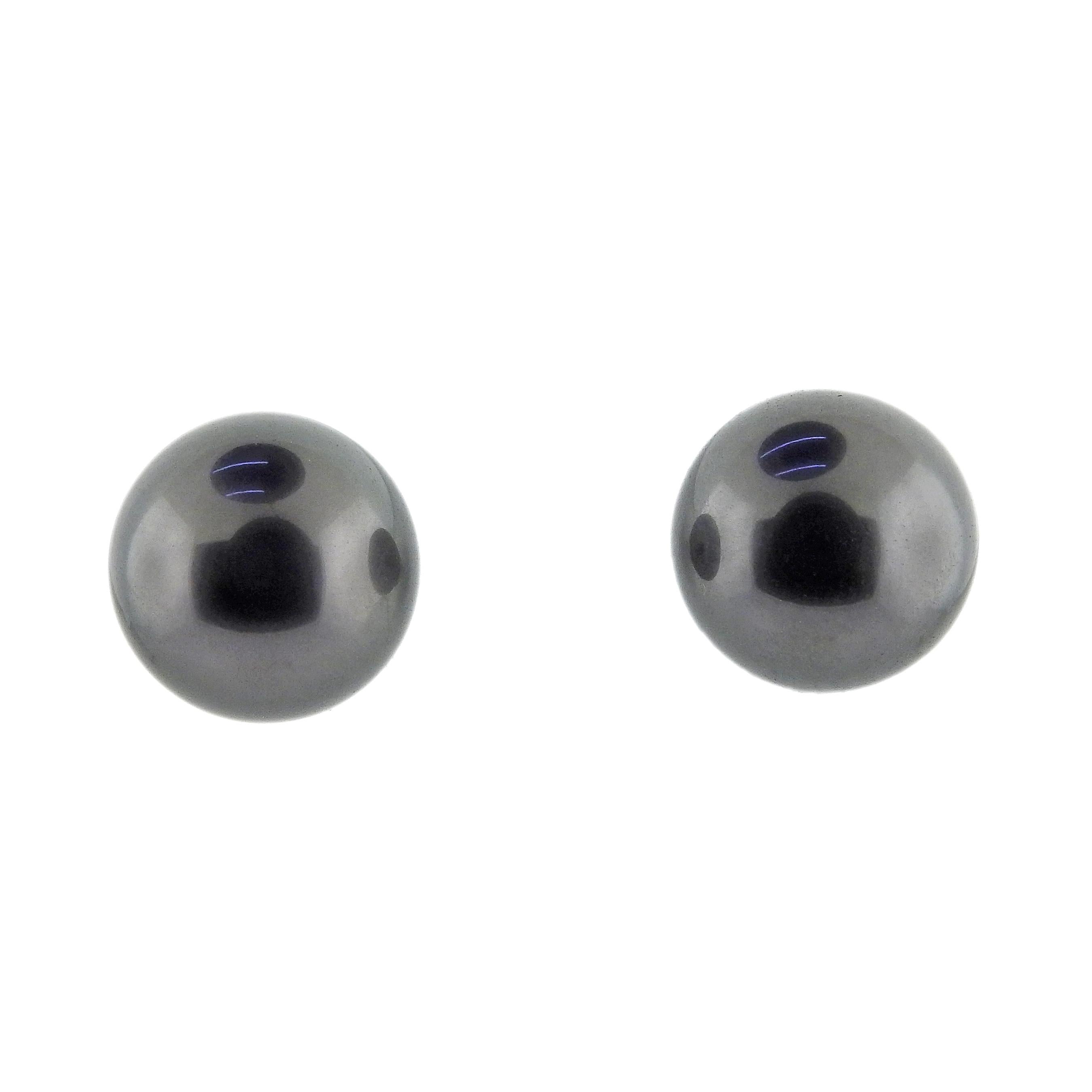 Pair of 18k gold stud earrings by Mikimoto, with A+ black South Sea pearls 10mm. Retail $4200.  Earrings measure 10mm in diameter. Marked: Mikimoto, 750. Weight is 5.3 grams. Come with box and COA. 