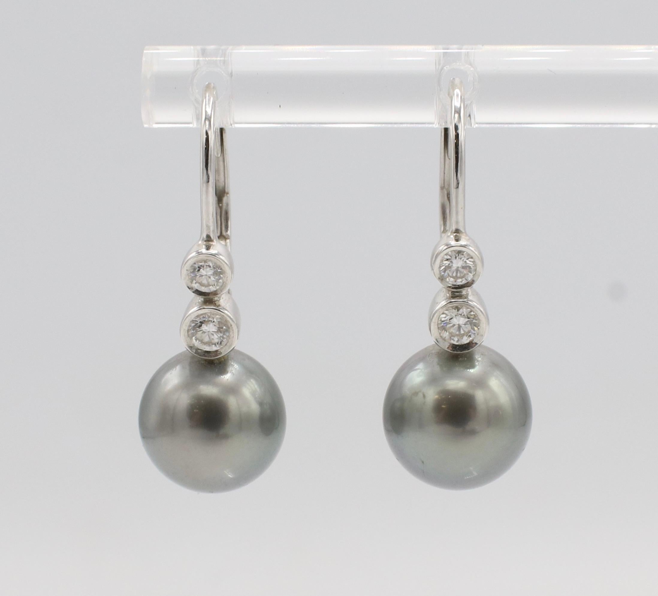 Mikimoto Black South Sea Pearl & Natural Diamond 18K White Gold Drop Earrings
Metal: 18k white gold
Weight: 3.7 grams
Diamonds: Approx. 0.22 CTW round F VS natural diamonds
Pearls: 9mm, round black South Sea cultured pearls
Drop: 23mm
