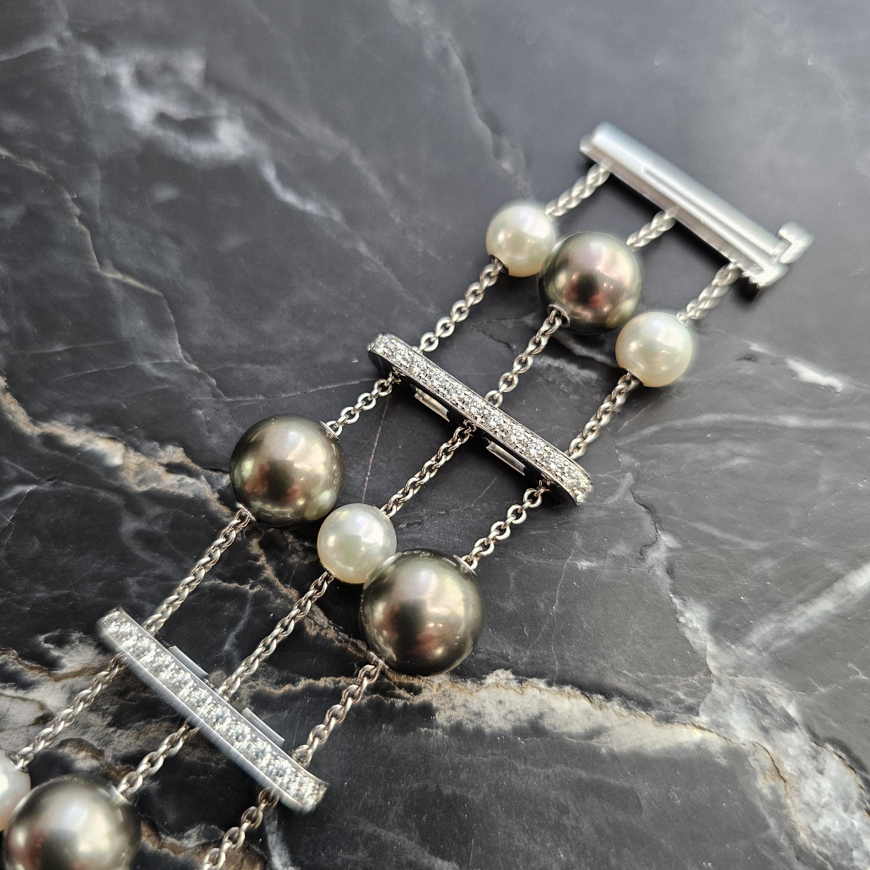 Presenting an exquisite Mikimoto Pearls in Motion collection bracelet, a true masterpiece in design and elegance.

This stunning piece is crafted from solid 18k white gold. It features lustrous Tahitian (Peacock coloration) and white Akoya pearls,