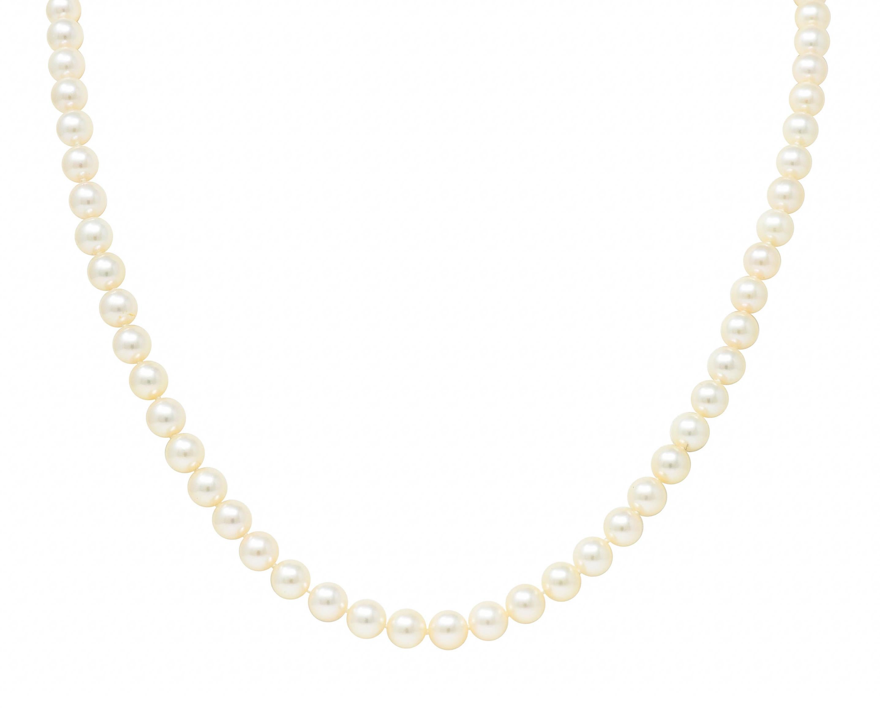 Strand necklace is hand knotted and comprised of 6.5 mm round pearls

Well matched in cream body color with some rosè overtones and excellent luster

Completes as an 18 karat gold pearl clasp - deeply engraved and forms a knot motif

Accented by a
