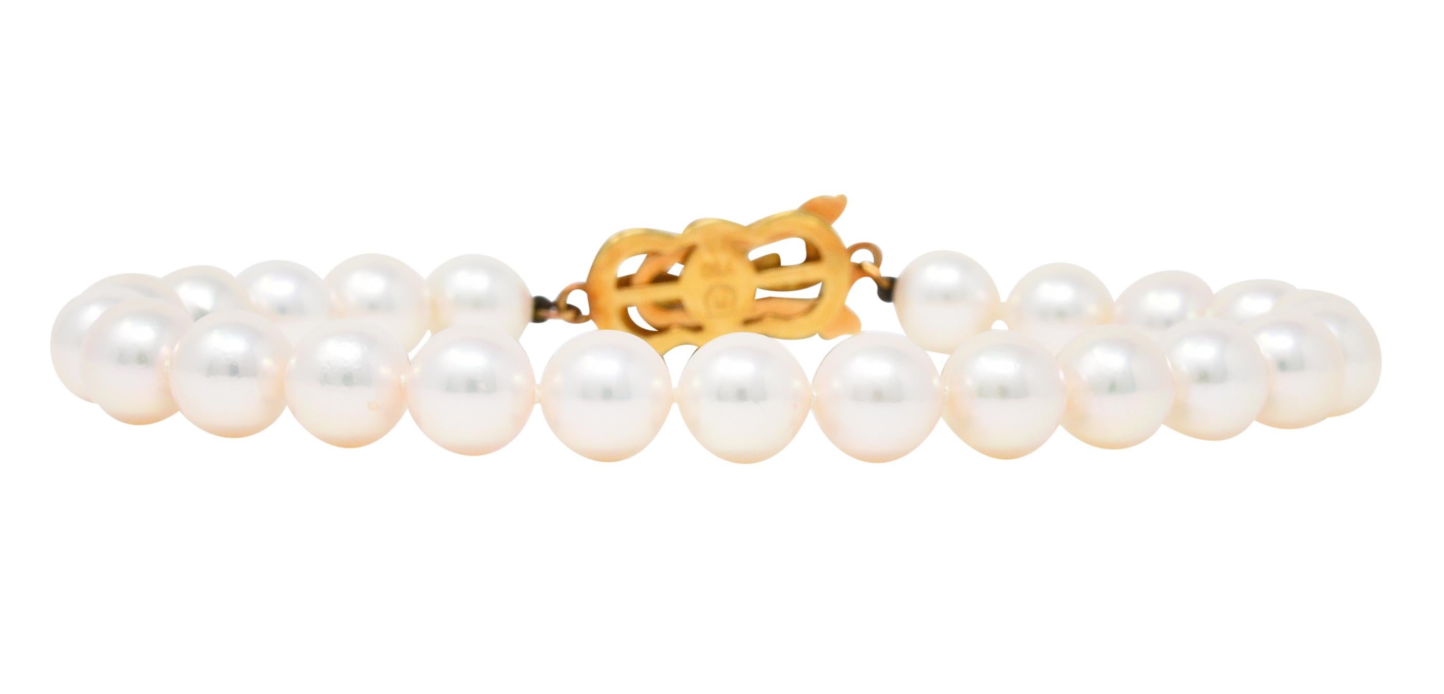 Strand bracelet is hand-knotted and comprised of 7.0 mm round pearls

Well matched in white body color with strong rosè overtones and excellent luster

Completes as an 18 karat gold pearl clasp - deeply engraved, forming a knot motif

Accented by a