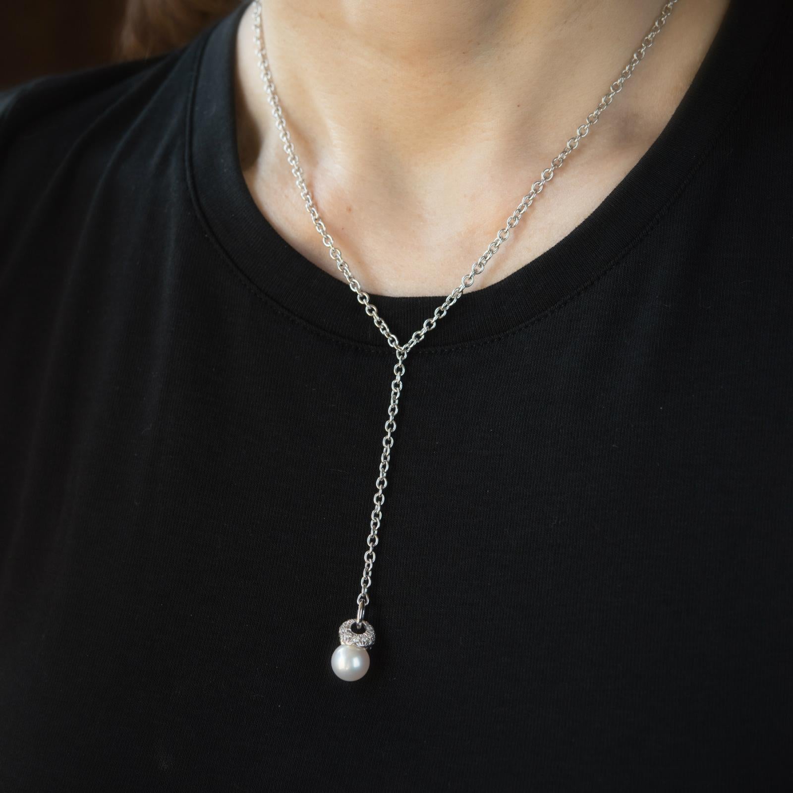 Elegant Mikimoto drop necklace, crafted in 18 karat white gold.  

Mikimoto cultured akoya pearl measures 9mm, accented with an estimated 0.25 carats of round brilliant cut diamonds (estimate at G color and VS2 clarity).

The necklace measures 16