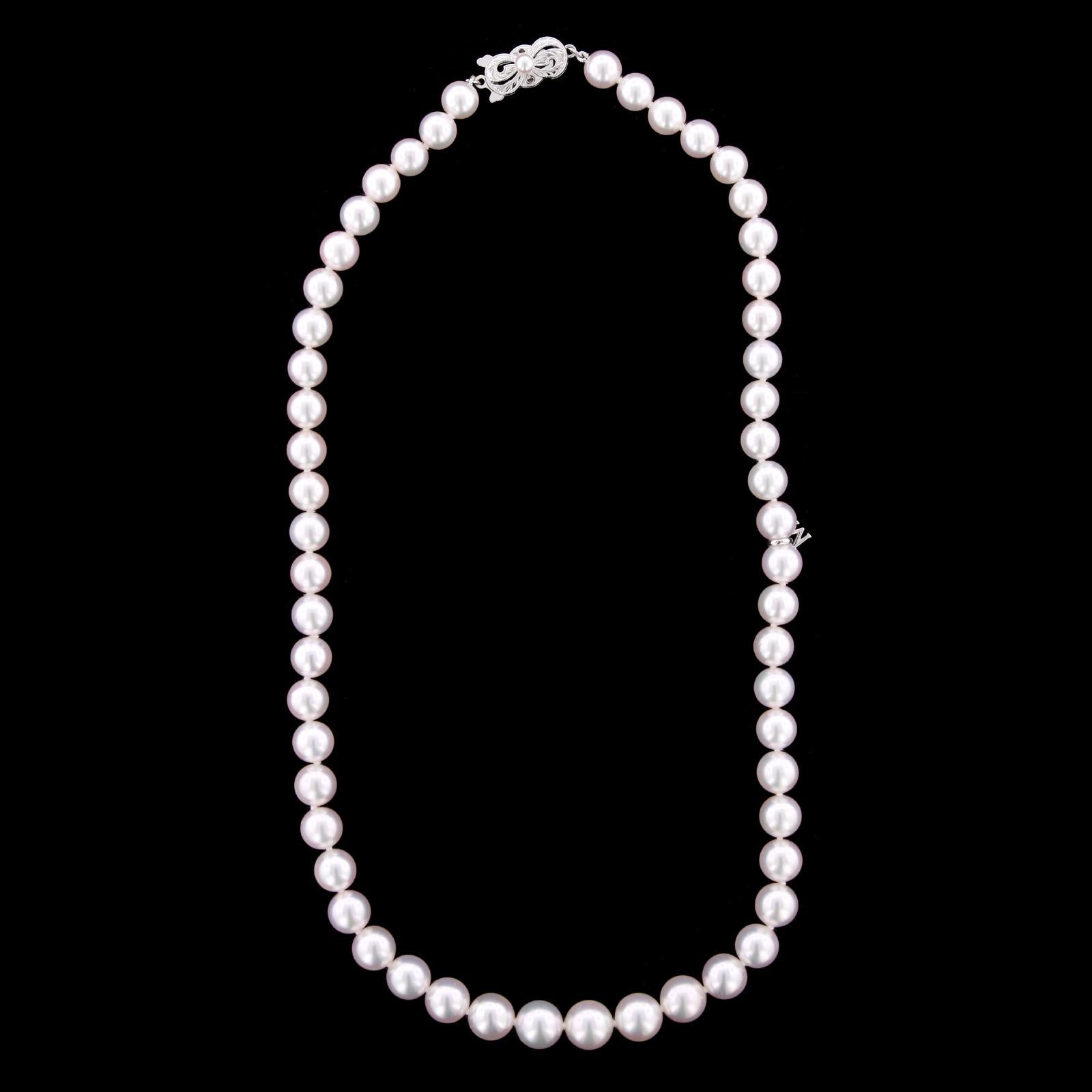 Mikimoto Cultured Pearl Necklace. The necklace is comprised of 55 cultured
pearls graduating in size from 7.00 to 9.00mm., completed by a signature 18K
white gold clasp set with a cultured pearl, length 18