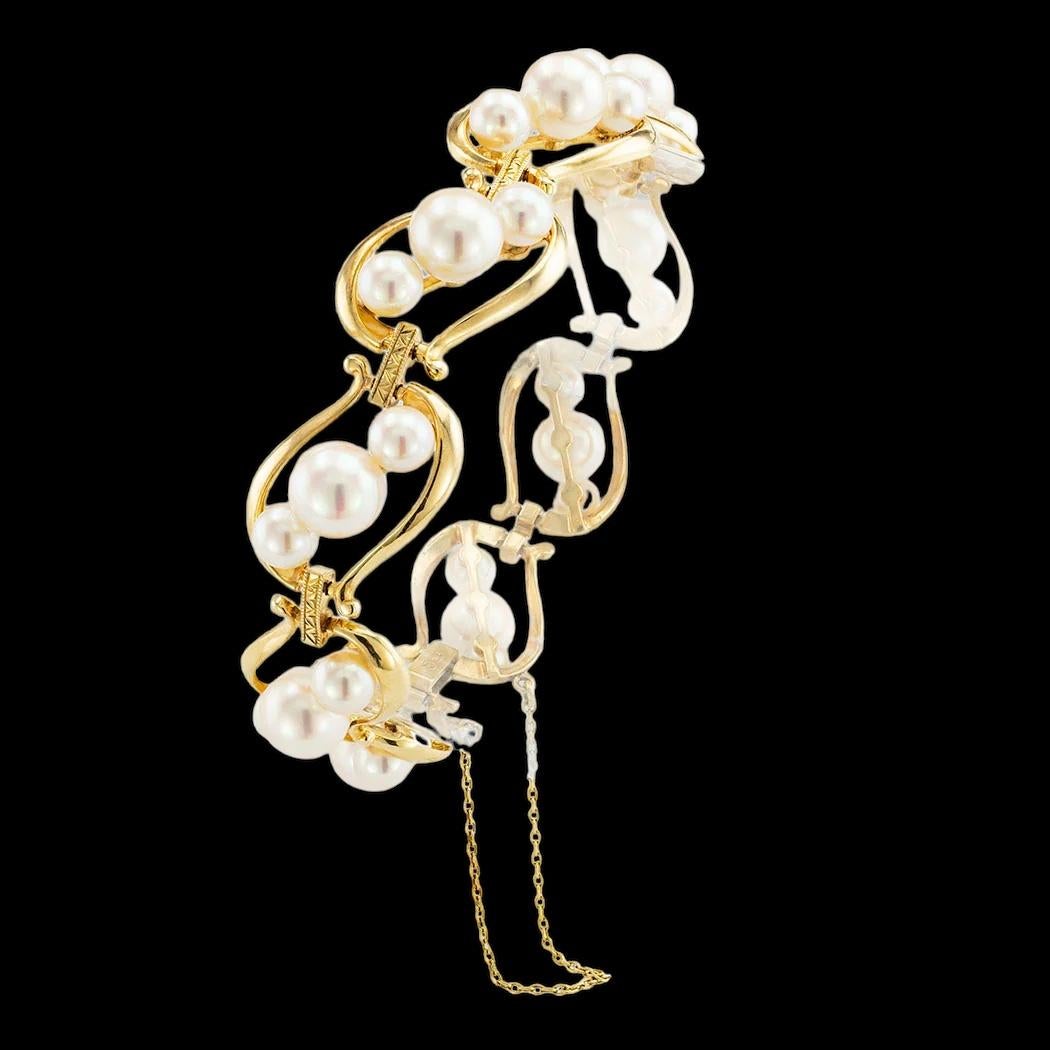 Mikimoto Akoya cultured pearl yellow gold link bracelet circa 1950. 

ABOUT THIS ITEM:  #B-DJ69i. Scroll down for detailed specifications.  This vintage bracelet features oval, open links, each centering a trio of lustrous pearls graduating from the