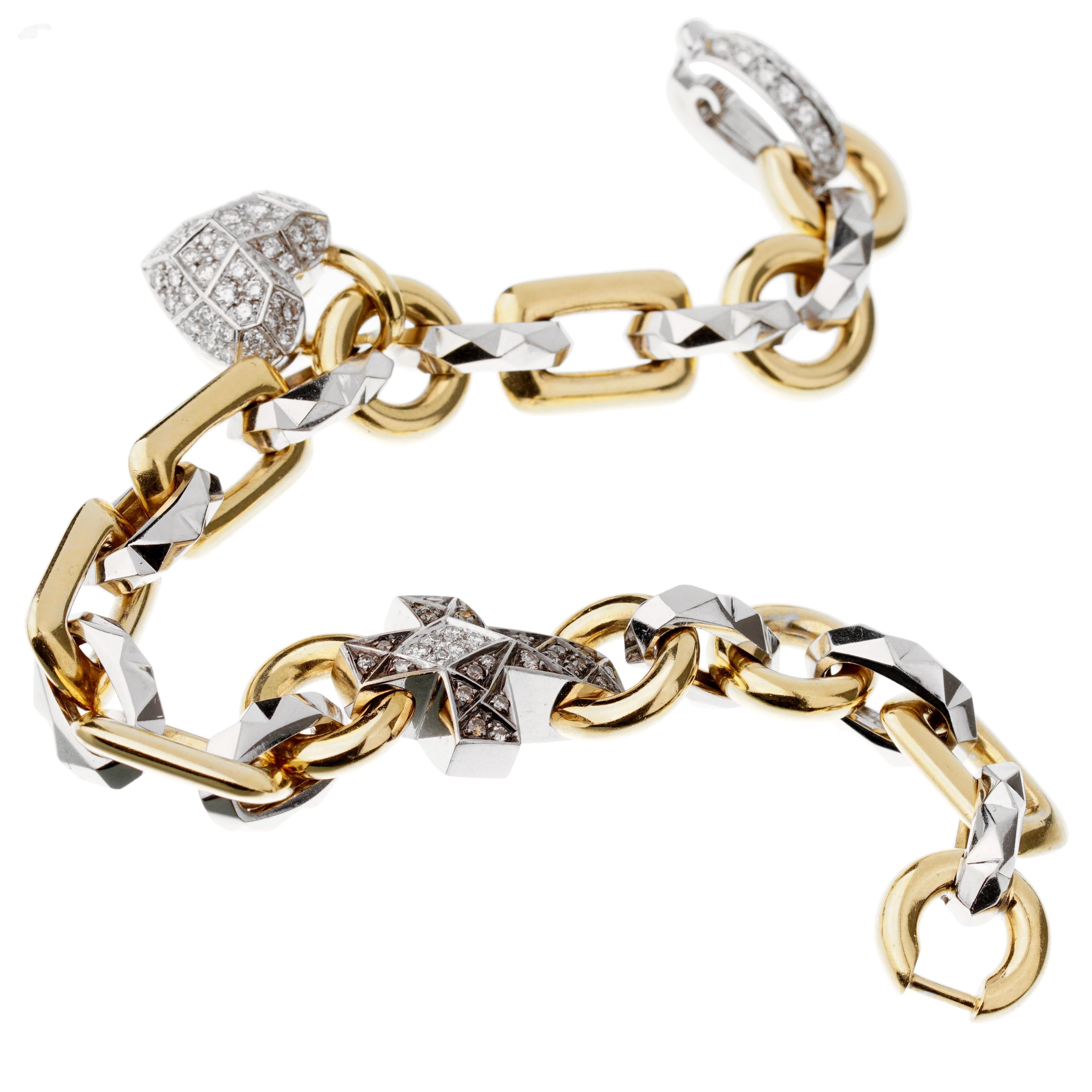 A unique bracelet by Mikimoto showcasing a faceted heart and cross adorned with round brilliant cut diamonds (.90ct) in 18k white and yellow gold. The bracelet measures 7.4