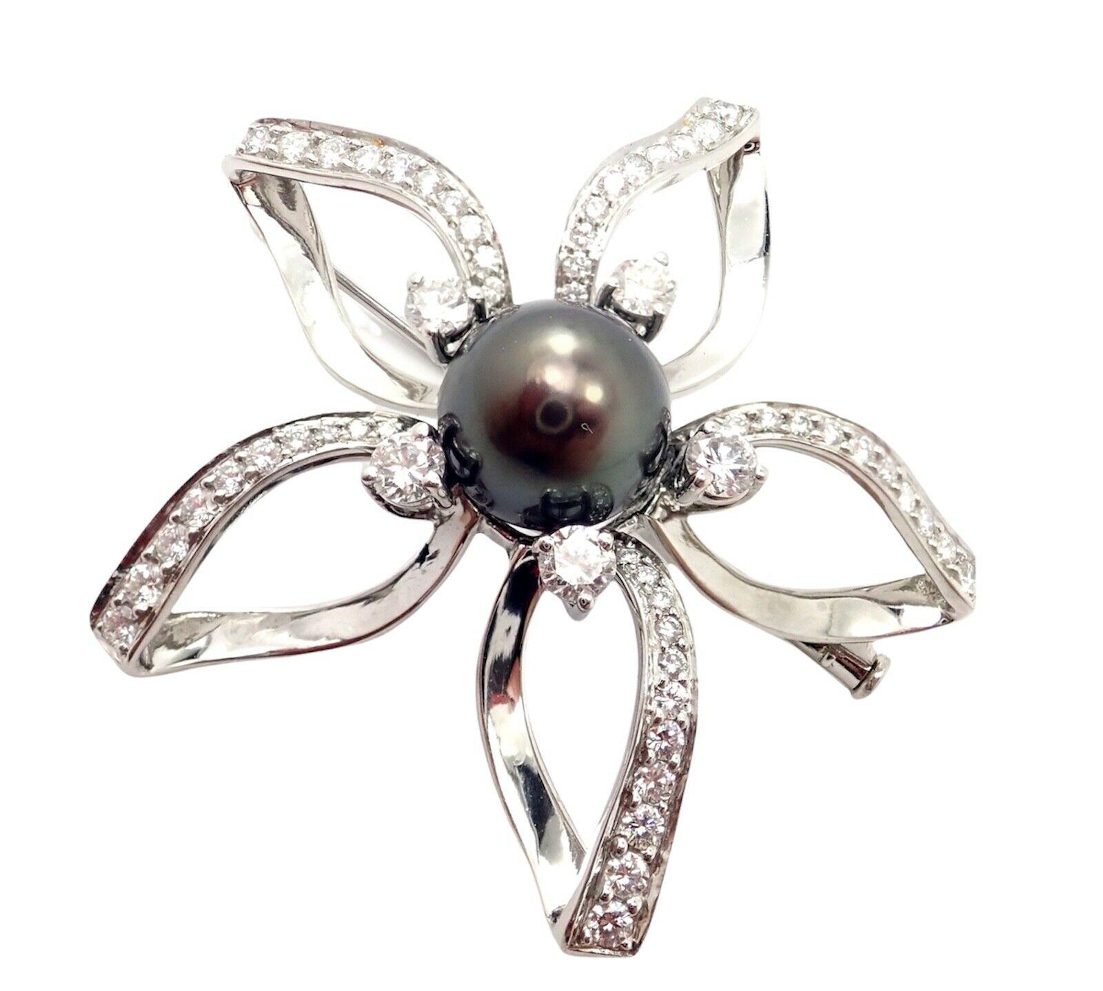 Platinum Diamond and Large Tahitian Pearl Flower Pin Brooch by Mikimoto. 
With 60 Round brilliant cut diamonds VS1 Clarity, G color 
total weight approximate 1.50ct
1 High Luster Black Tahitian South Sea Pearl 11mm in Size
Details: 
Measurements: