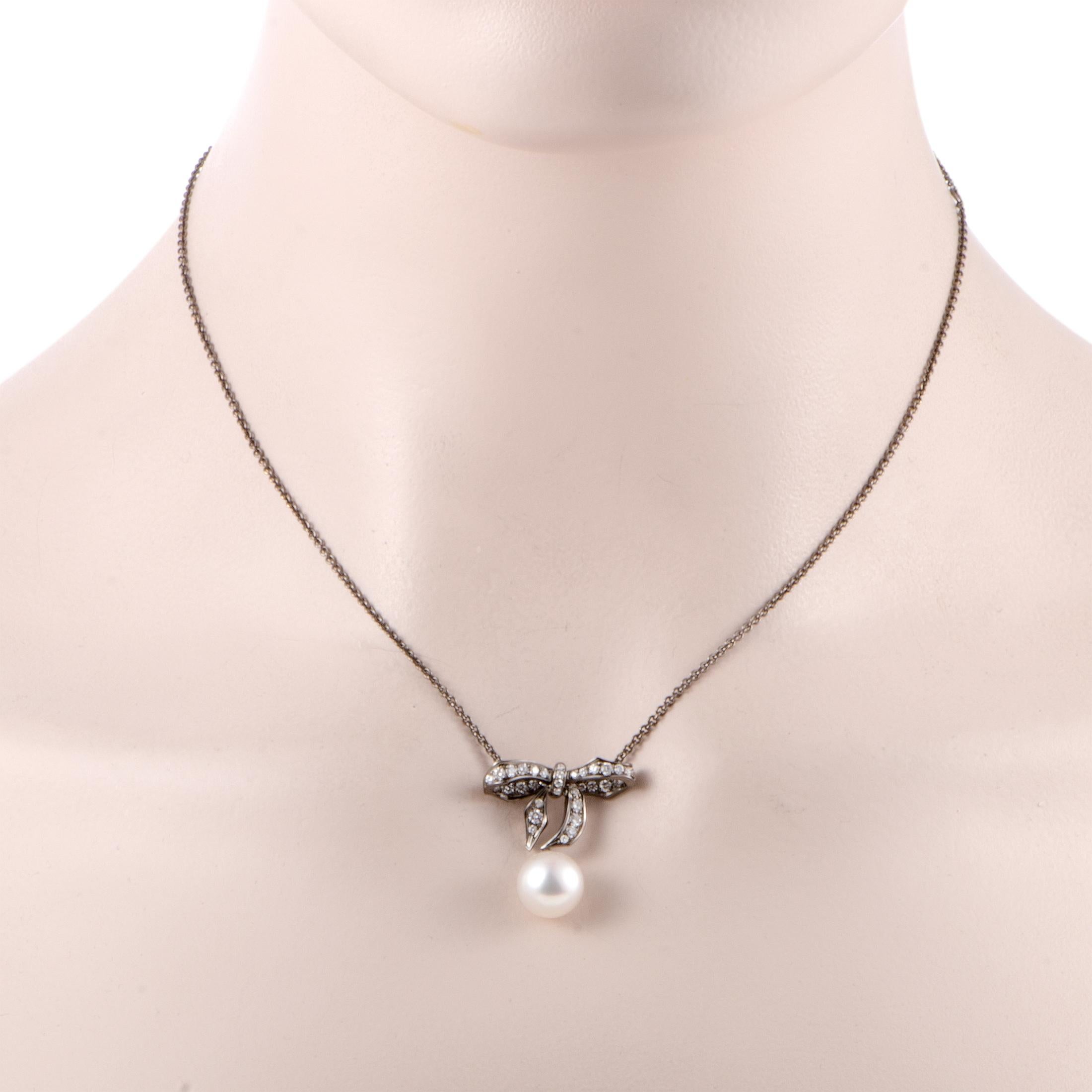 This stylish 18K white gold necklace by Mikimoto has a sublime aesthetic effect created by impeccable craftsmanship. Its pendant's extraordinarily spectacular design is accentuated by an adornment of scintillating diamonds, weighing 0.57ct, and an