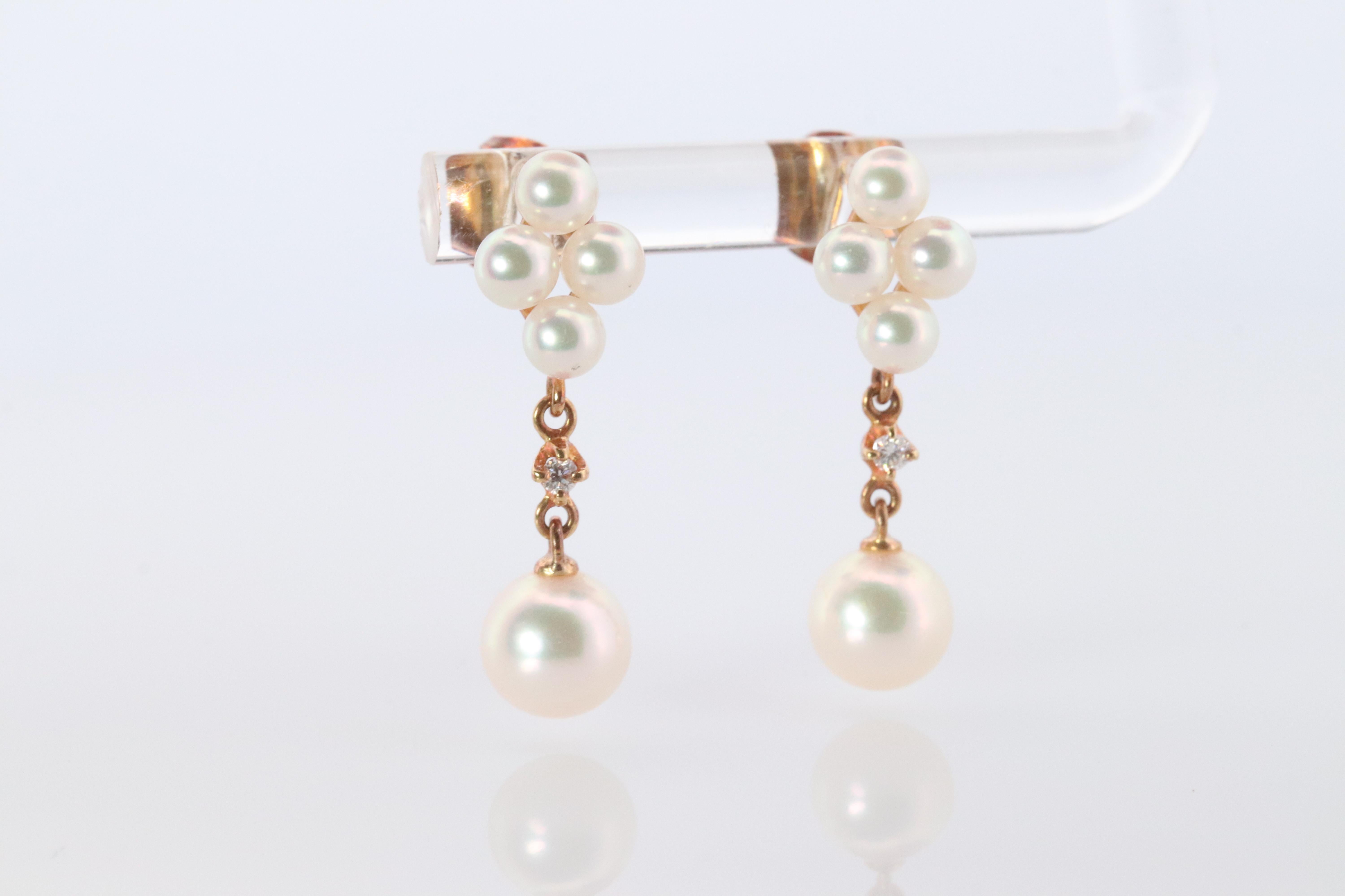 Stunning Designer earrings. World Renowned MIKIMOTO pearls.

Pierced Dangle earrings.

Cluster Pearls with Diamond Dangles.
18k Yellow gold.

Condition: Shows little to no signs of wear.

Details:
hallmark M for Mikimoto
18k Yellow Gold
3.5mm and