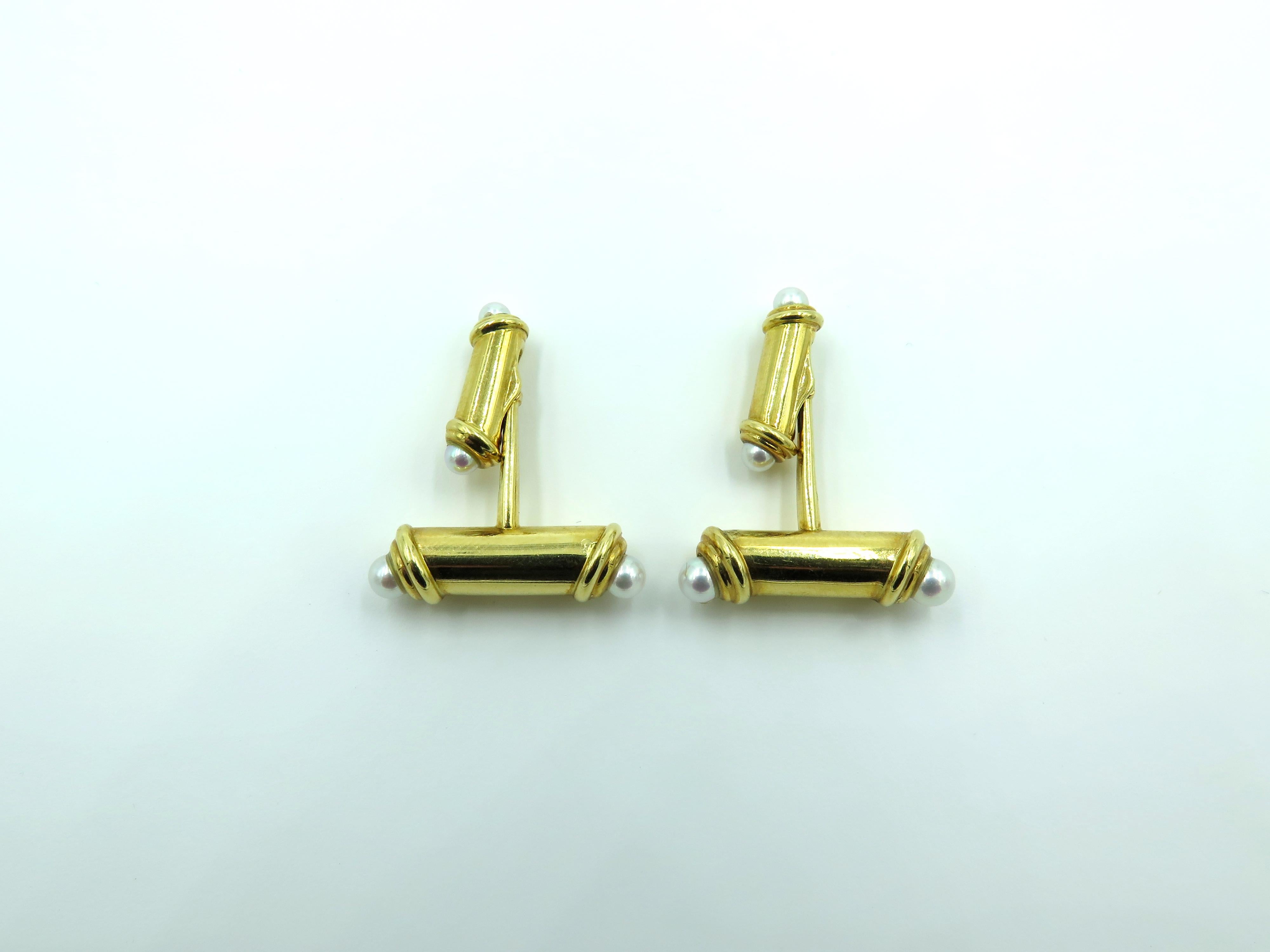 A pair of 18 karat yellow gold and pearl cufflinks. Mikimoto. Each double polished gold bar terminating in white pearls, measuring from approximately 3.50 to 4.50mm. Length of bar is 1 inch. Gross weight is approximately 16.1 grams. With maker’s