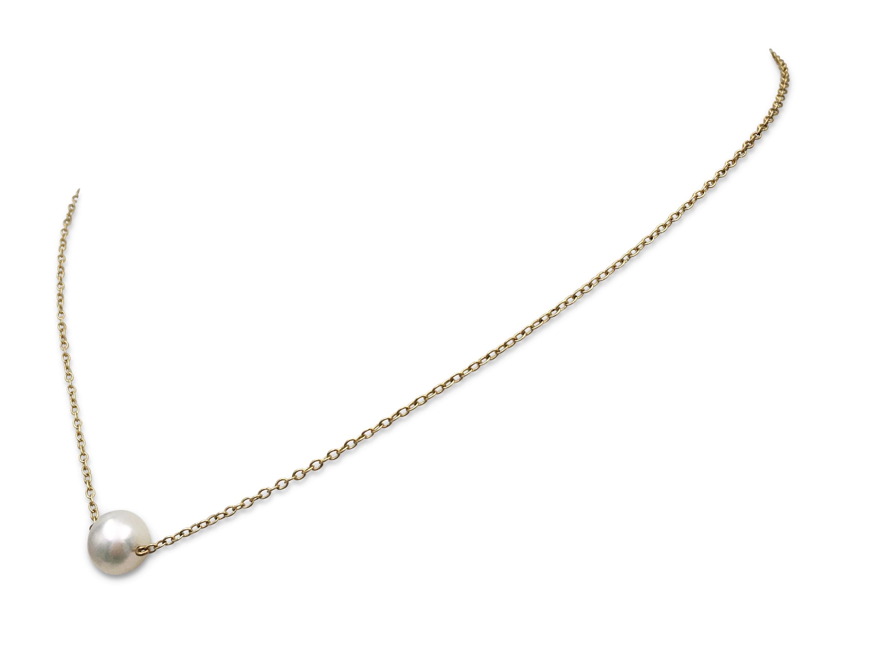 Authentic Mikimoto necklace crafted in 14 karat yellow gold and featuring a single Akoya cultured pearl measuring 7.7mm. Signed M, K14. The necklace is not presented with the original box or papers. CIRCA 2000s. 