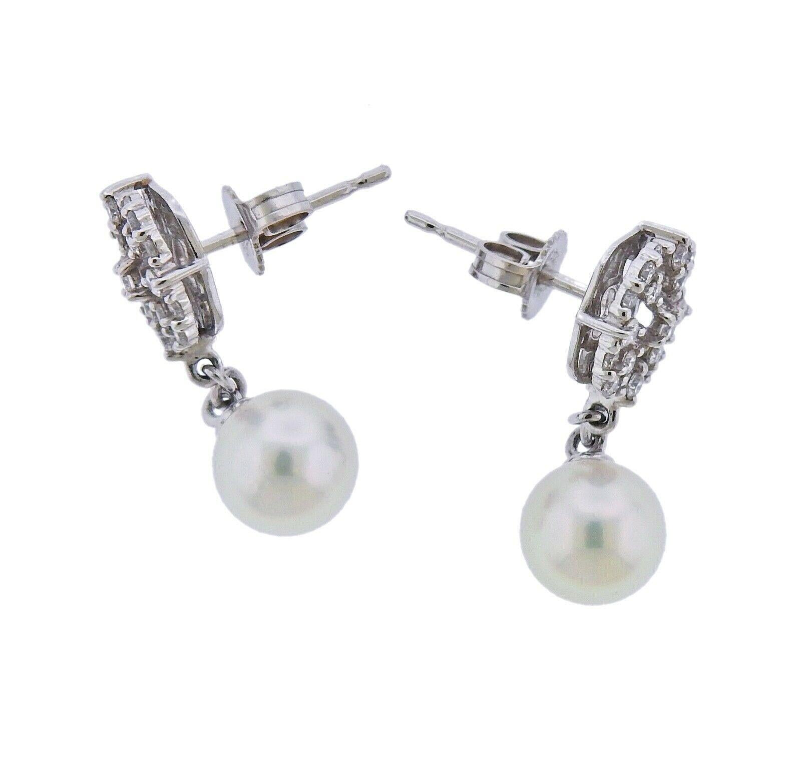 Pair of new Mikimoto earrings in 18k white gold with 7.5mm pearls and approx. 0.45ctw in G/VS diamonds. Retail $3300. Earrings are 25mm long. Weight - 5 grams. Marked: Mikimoto mark, 750.