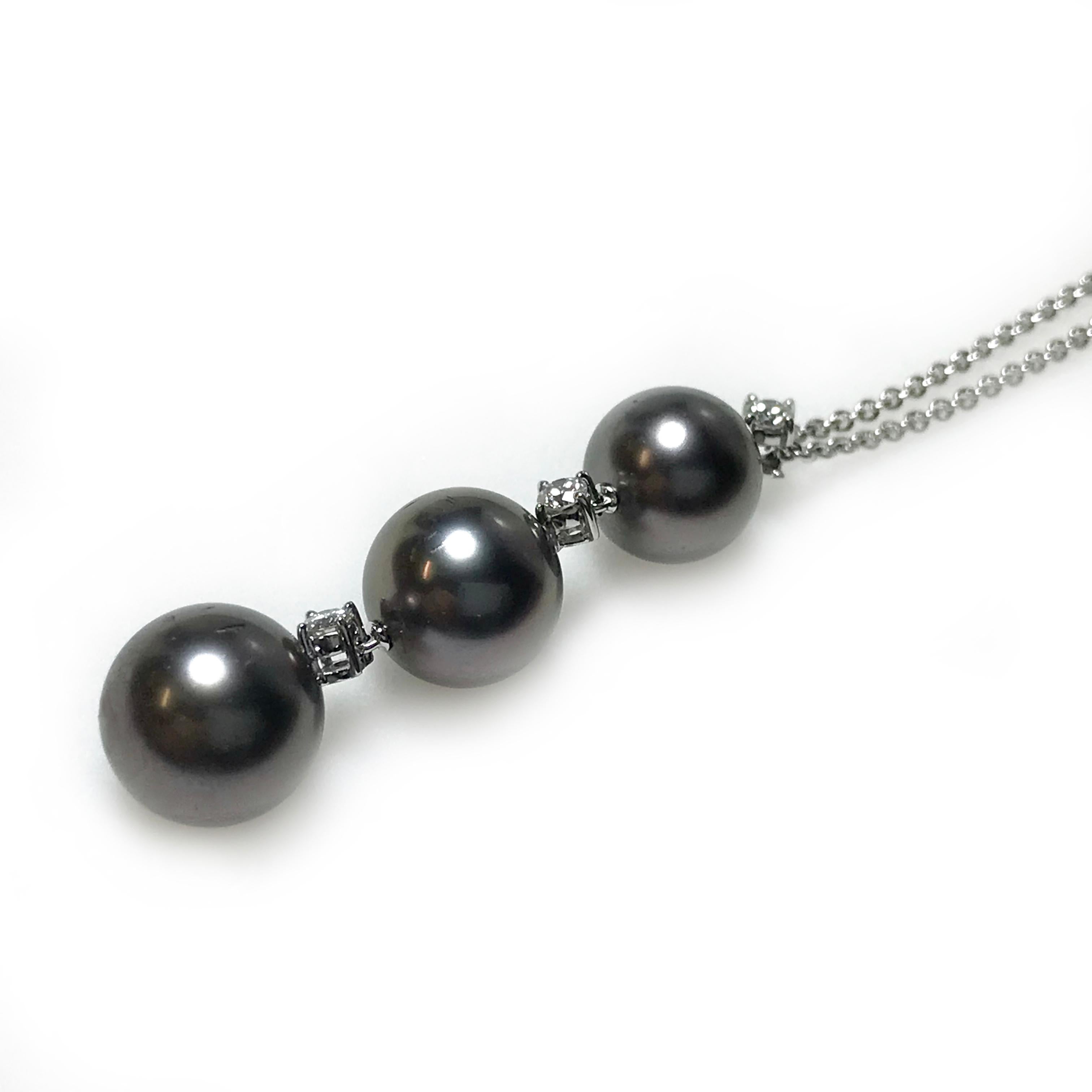 Gorgeous 18k white gold pendant/necklace with three alternating Akoya cultured black pearls and diamonds. The pearls range in size, 8mm, 8.5mm, and 9mm.  Known for their brilliant luster and rich color, Akoya pearls are a traditional symbol of