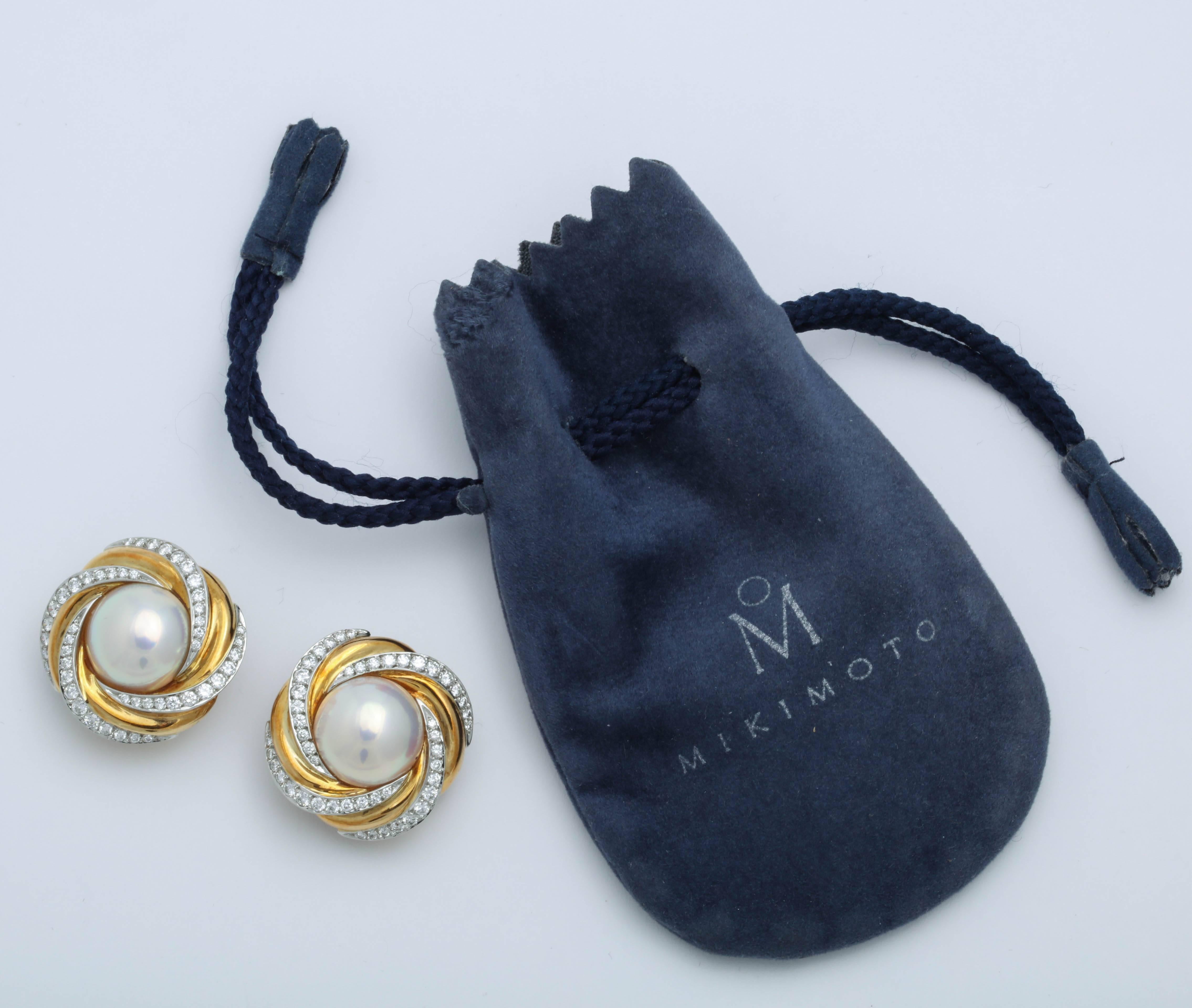Signed Mikimoto NY Mabe Pearl Earrings set in 18kt Yellow Gold swirls and offset by alternating  Diamond Swirls..  Very conservative but - at the same time - splashy!  Approx. 2 carat Diamond weight total.