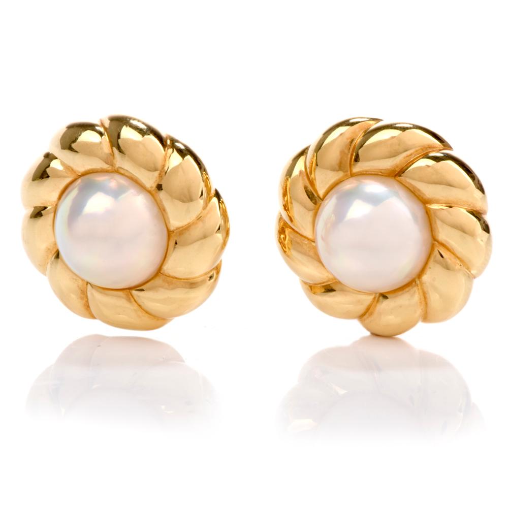 These bold vintage 198's Mikimoto earrings are crafted with 18-karat yellow gold, weighing 26.7 grams and measuring 23mm wide. Centered with a pair of bezel-set high lustrous Mobe pearls measuring approximately 14mm. Surrounded by a floral petal