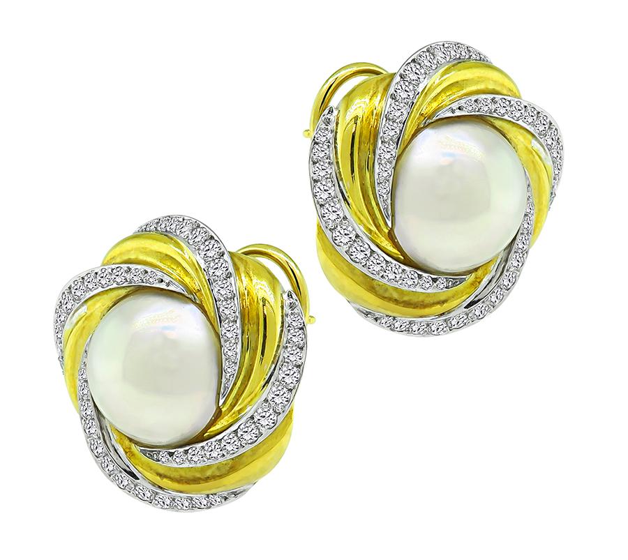 This is an amazing pair of two tone 18k yellow and white gold earrings by Mikimoto. The earrings feature two lovely pearls. The pearls are accentuated by sparkling round cut diamonds that weigh approximately 1.80ct. The color of these diamonds is G