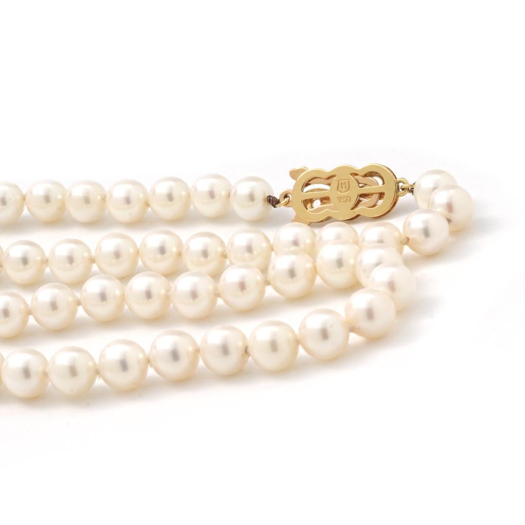 This previously-owned MikiMoto pearl strand necklace is 6.5mm wide, 30 inches in length, made of 18K yellow gold, and weighs 30.20 DWT (approx. 46.97 grams). It also has 106 round pearls.
