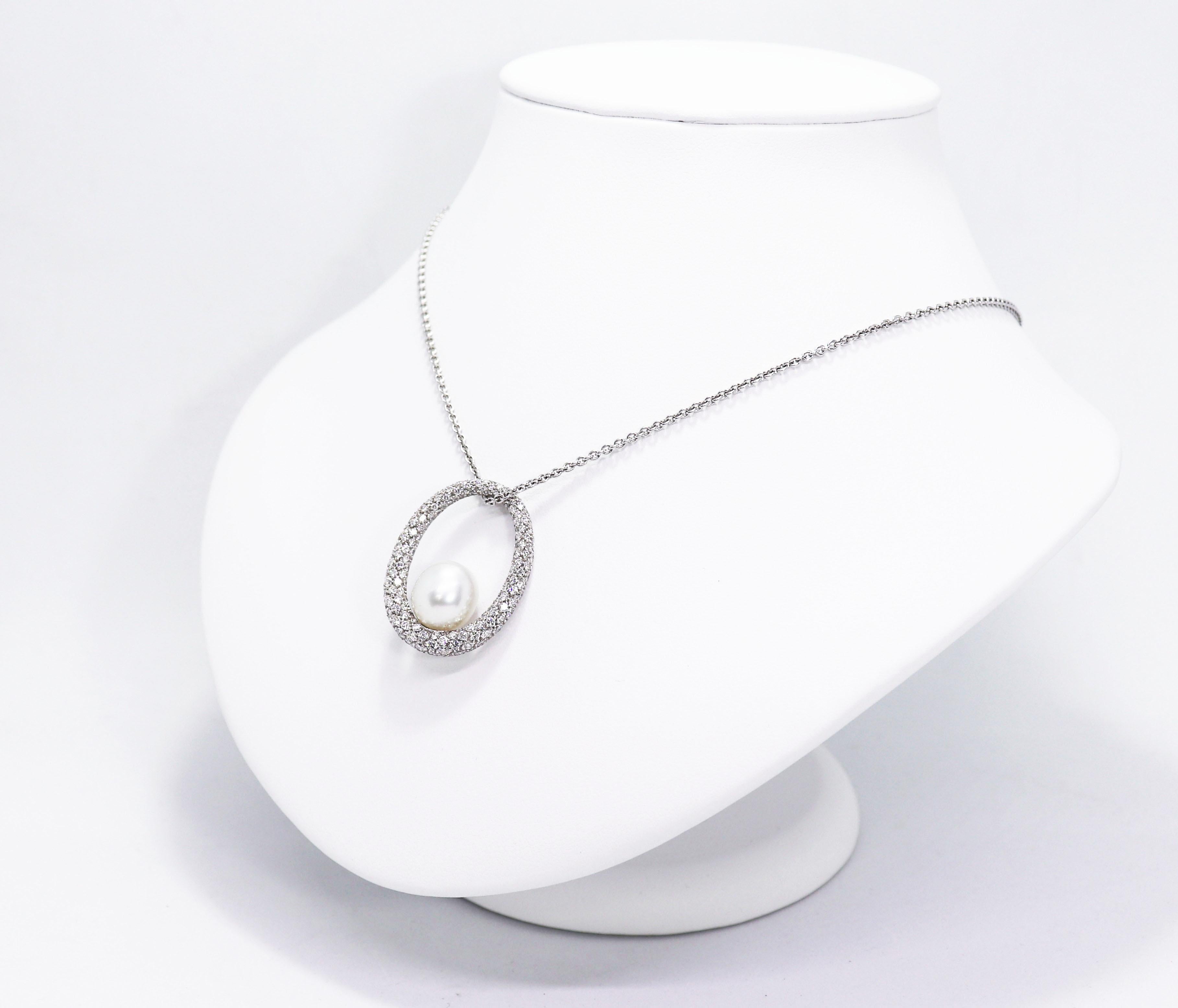 Elegant pendant featuring a beautiful cultured pearl measuring approximately 11x12mm sat in the centre of an oval 18 carat white gold mount, pavé set with approximately 3.00 carats of fine quality round brilliant cut diamonds. The pendant measures