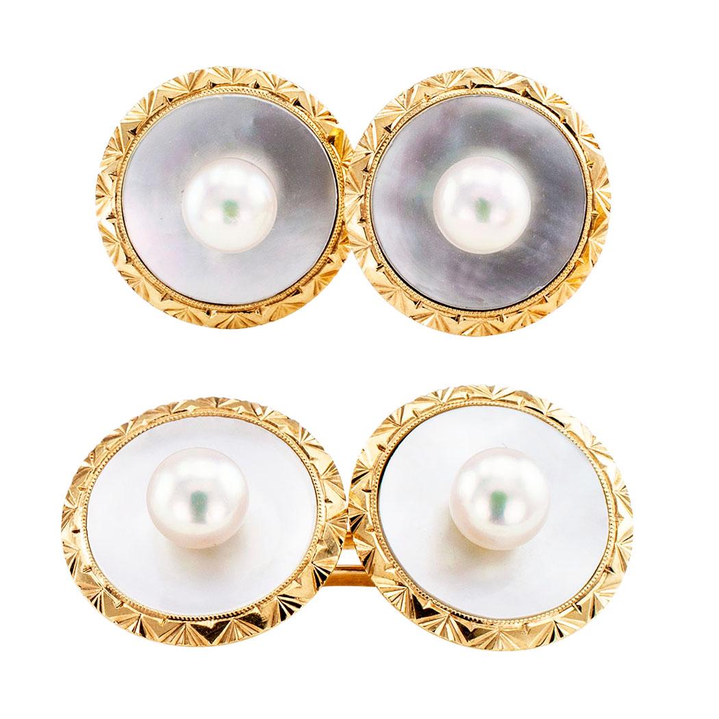 Mikimoto pearl mother of pearl and gold cufflinks circa 1950. The matching, double sided designs feature a cultured pearl in the center of each face, backed with round white mother of pearl, within a conforming bezel decorated by a geometric