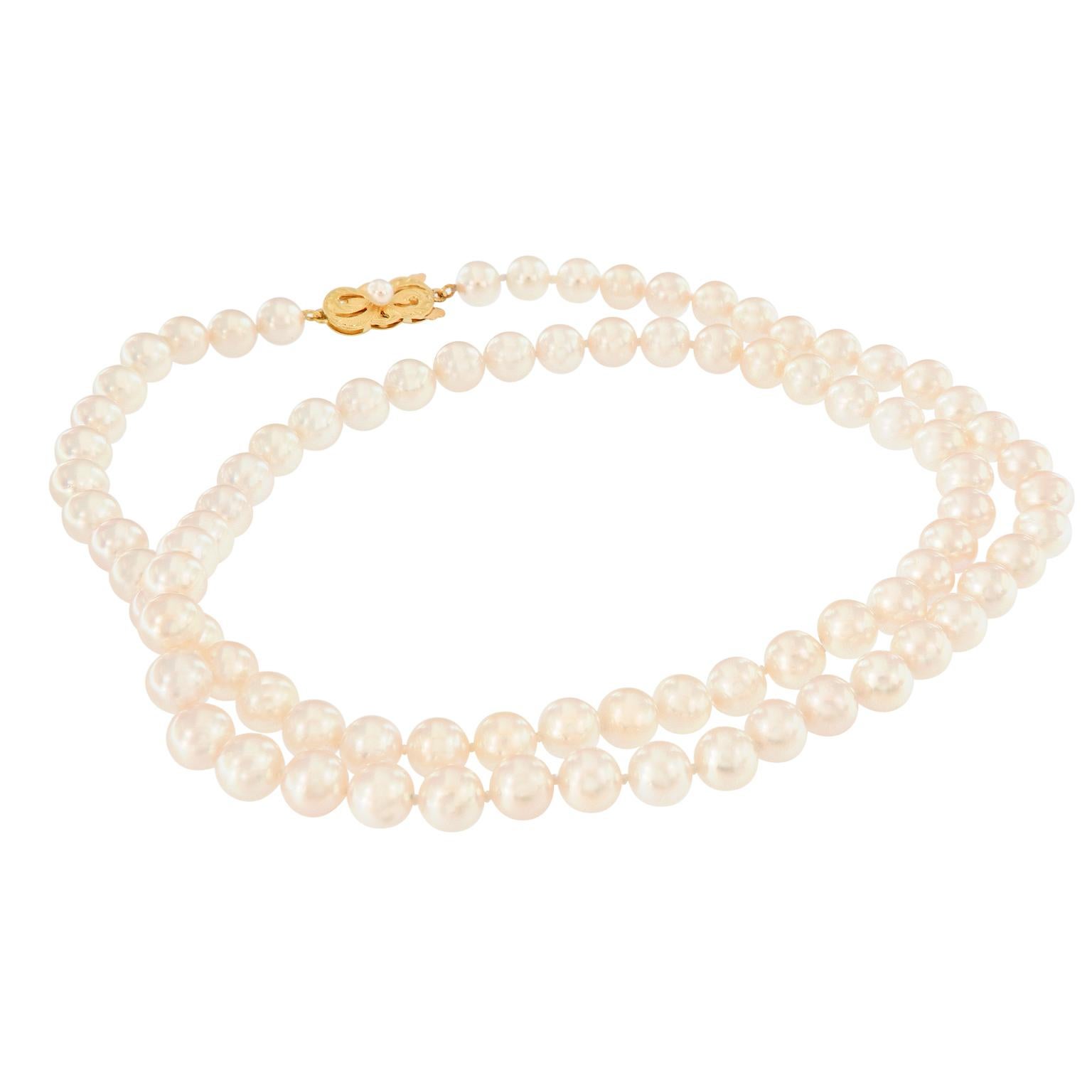 This pretty Mikimoto pearl necklace features 6.5-7 mm Akoya pearls and is 24 inches long. The clasp is 18k yellow gold and is set with a pearl at its center. This previously owned piece is in excellent condition. Weighs 31.9 grams.