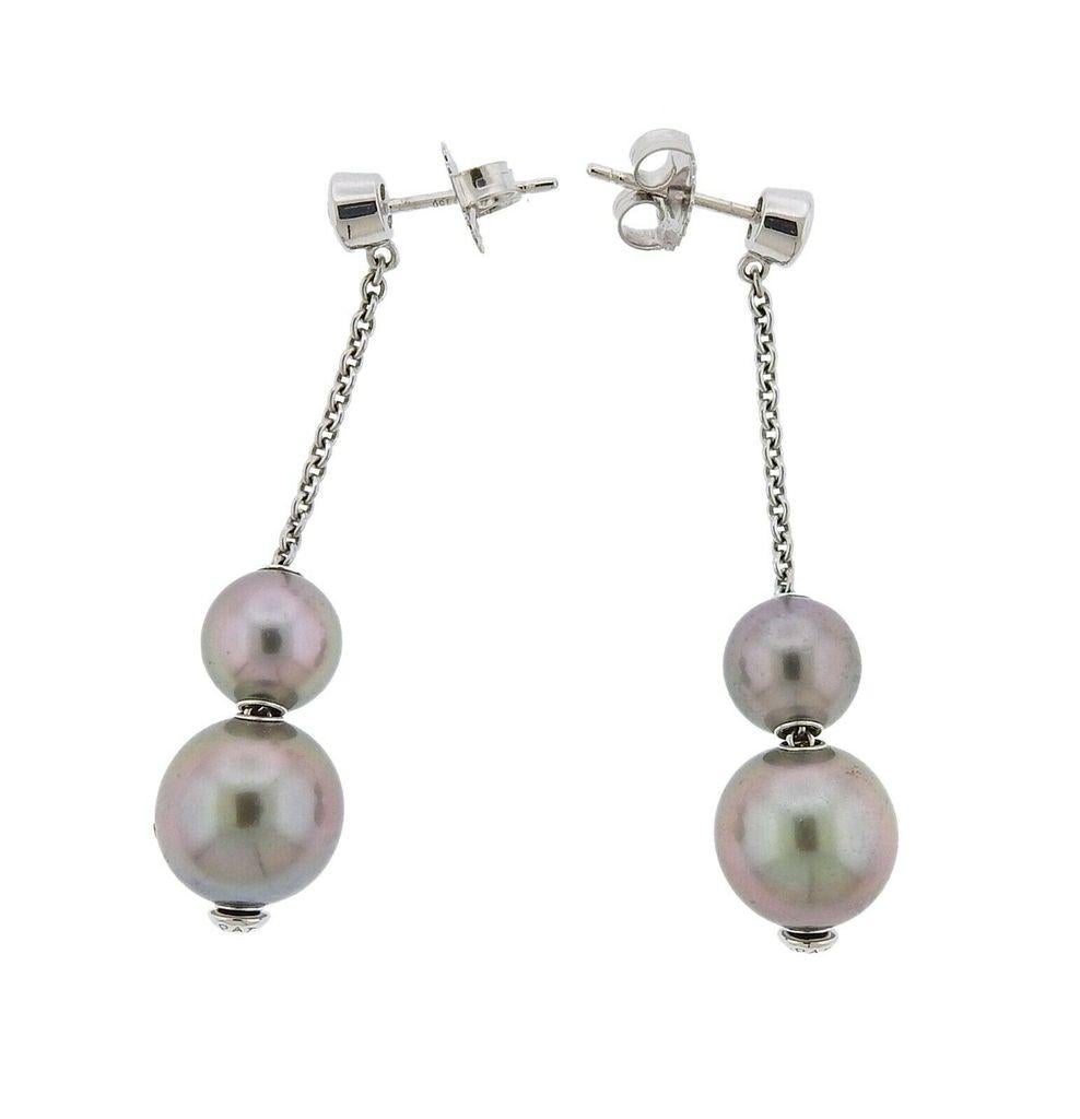 Pair of 18k white gold drop earrings by Mikimoto for Pearls in Motion collection. Featuring 8mm to 10.5mm Tahitian pearls and approx. 0.16ctw in G/VS diamonds. Earrings measure 48mm long. Total weight 7.4 grams. Marked Mikimoto Hallmark, 750, 14k