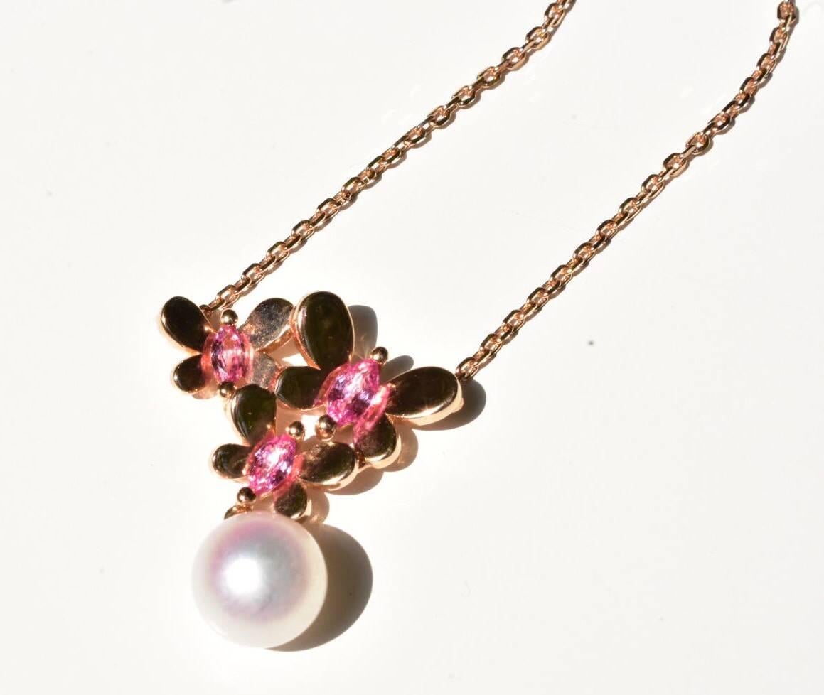 A Mikimoto pearl and pink sapphire necklace set in 18k rose gold. The necklace features a pendant with three butterflies with pink sapphire and a suspended pearl.

Pearl size: pearl 7.5mm, pink sapphires

Measurements: necklace is 16