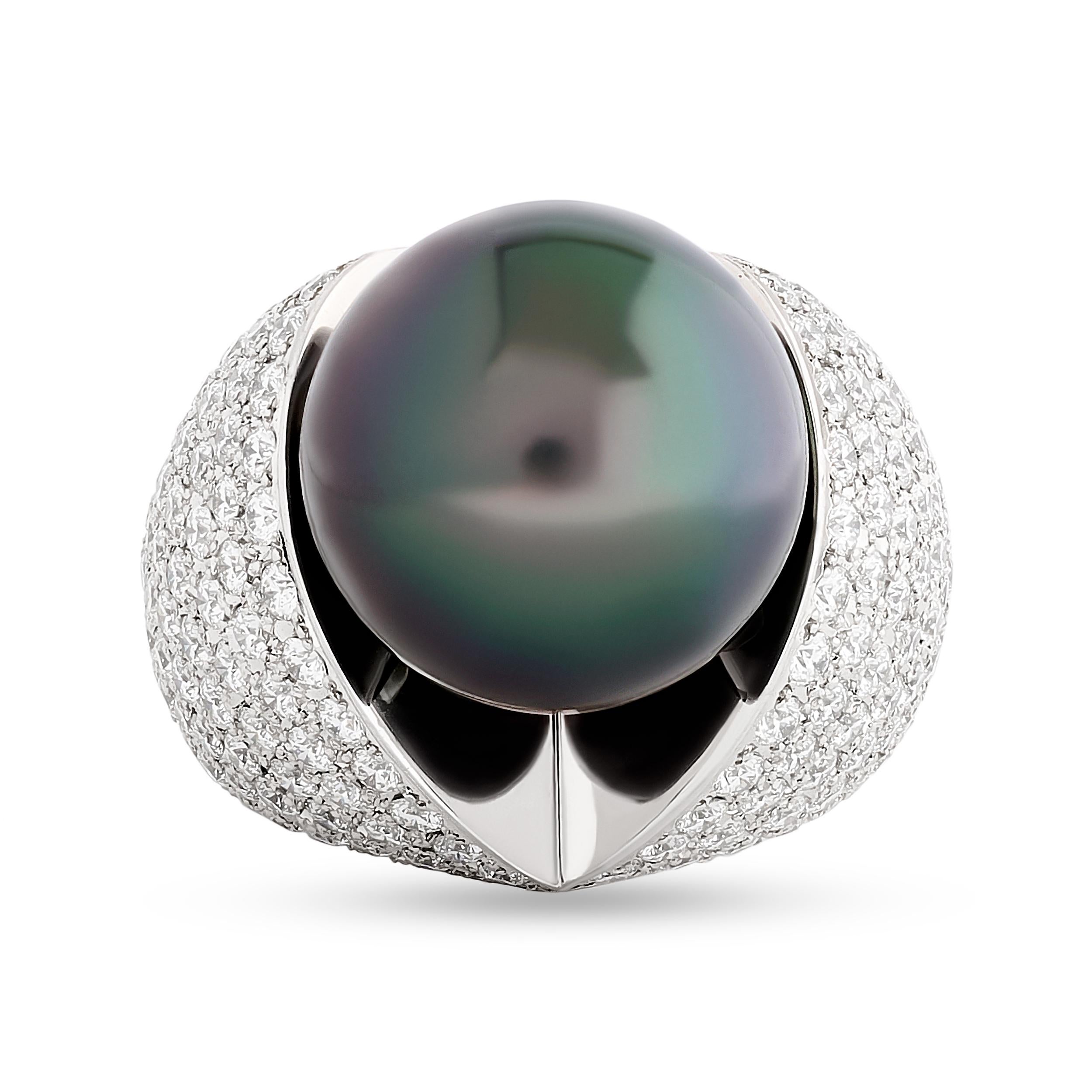 A Mikimoto black pearl, accentuated by a ring of pave, sparkling diamonds. 
The black pearl is approximately 16.00 millimeters. The total diamond weight is approximately 6.78 carats; color F-G and clarity VS. 

Ring size US 6.50
Signed with the
