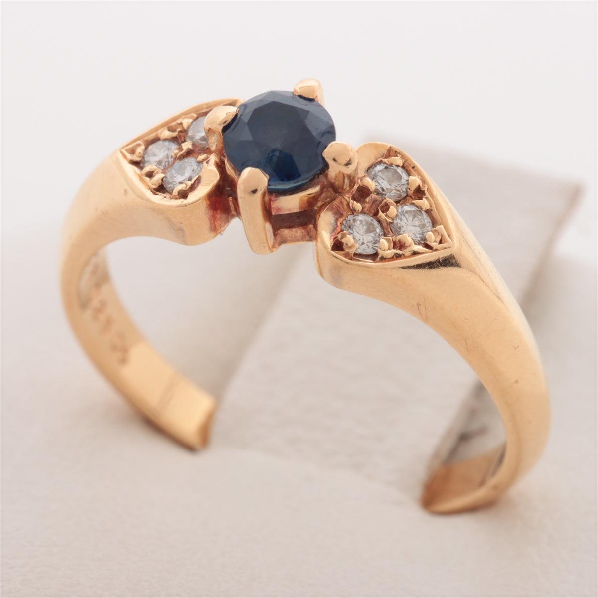 The Mikimoto Sapphire Diamond Ring in yellow gold is a luxurious piece that showcases exceptional craftsmanship and elegance. Featuring a stunning blue sapphire as the centerpiece, this ring is beautifully complemented by sparkling diamonds that