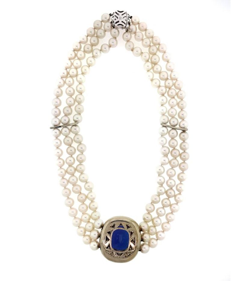 Mikimoto Tanzanite, Diamond & Pearl Choker Necklace in 18k White Gold 

Pearl and Tanzanite Choker by Mikimoto features a natural Cushion shaped Tanzanite weighing 30 carats estimated; set in 18k White Gold with 3 Rows of Round Brilliant Diamonds