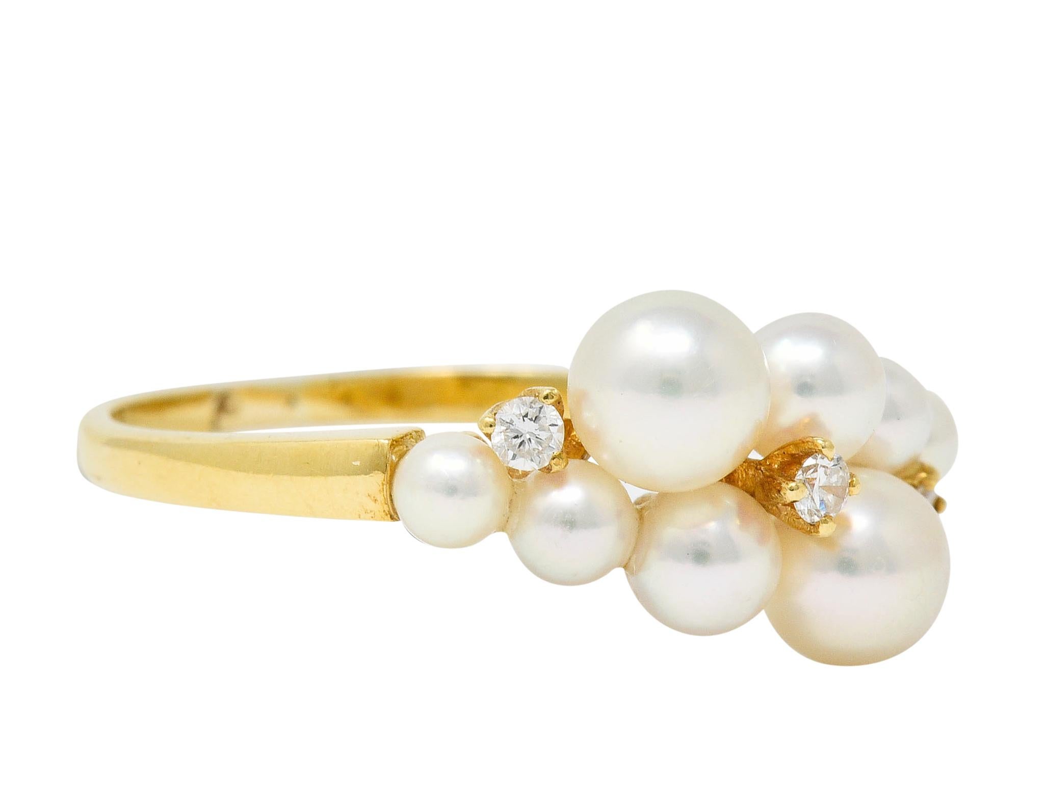 Band ring features a cluster of white cultured pearls with strong rosè overtones and excellent luster

Graduating in size from 4.8 mm to 2.8 mm

With three round brilliant cut diamond accents weighing in total approximately 0.06 carat

Maker's mark