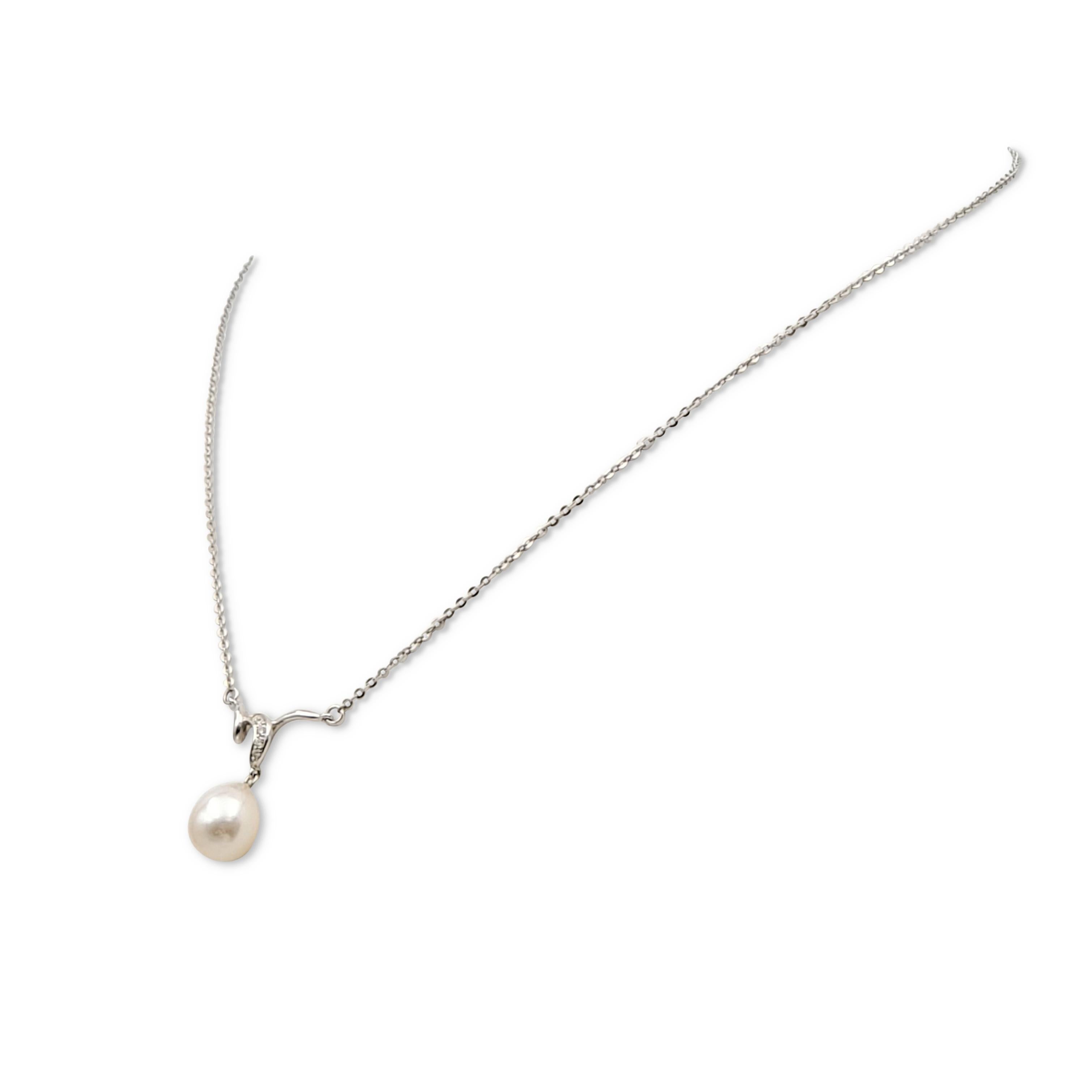Authentic Mikimoto pendant necklace crafted in 18 karat white gold featuring one Akoya pearl drop measuring 10.5 mm which is accented by high-quality (E-F color, VS) round brilliant cut diamonds weighing an estimated 0.05 cttw. Signed M, 750. The