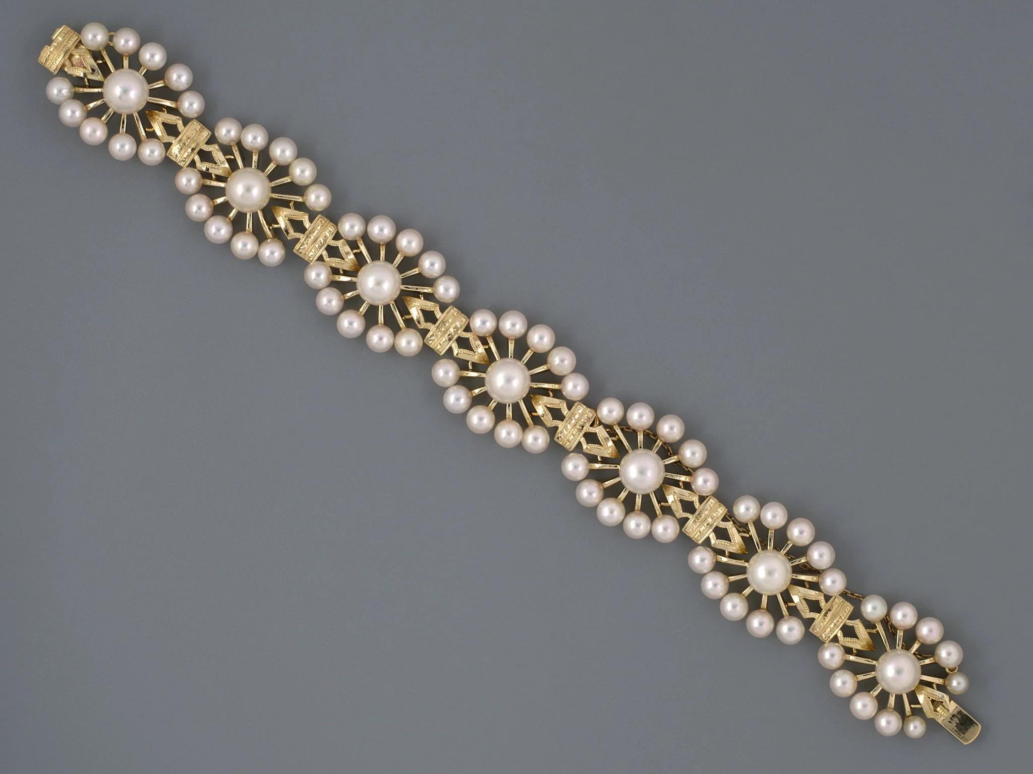 NYCID:#58927
Elevate your jewelry collection with this exquisite vintage bracelet, crafted from luxurious 14k yellow gold and adorned with a stunning floral design. Featuring a harmonious arrangement of 7 lustrous white pearls measuring 7mm and an