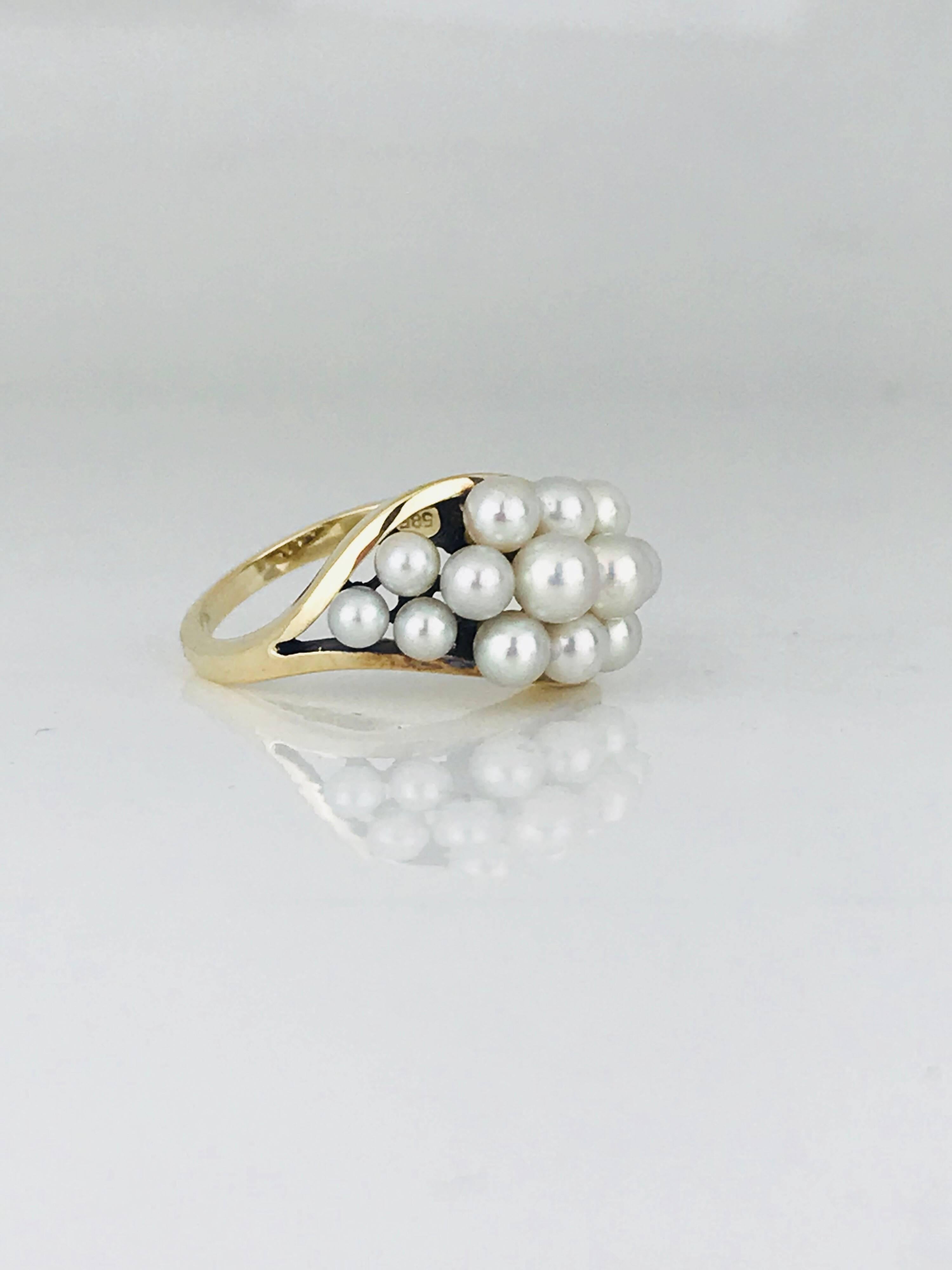  Lustrous, Mikimoto (16) white pearls of varying sizes are gracefully arranged in a tapered swirl on a highly polished 14 karat yellow gold ring.

Mikimoto pearls range in size from 3.0 mm to 5.5 millimeters.

Ring is a size 6.5.

GIA Gemologist