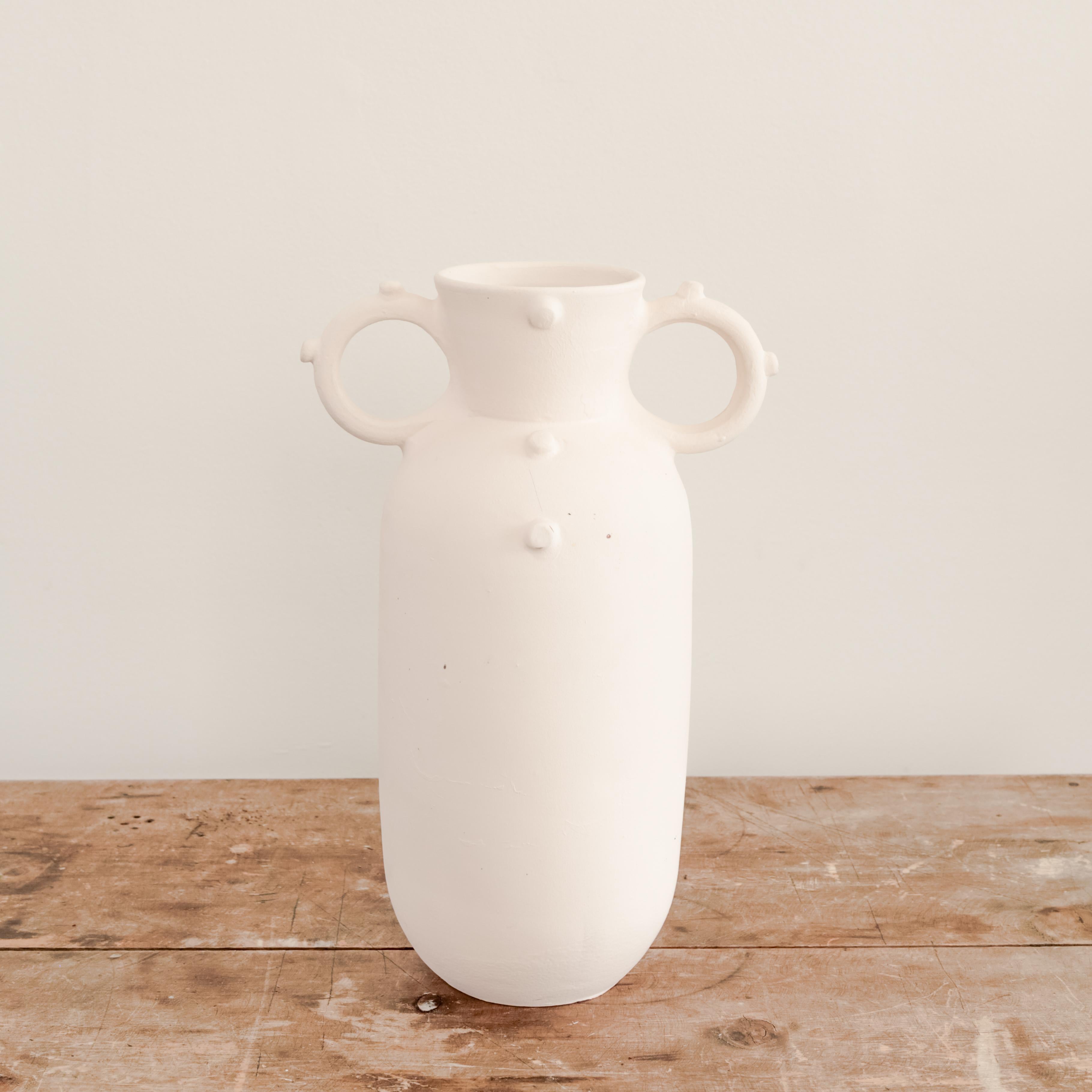 Unglazed white ceramic Miku vase with handles.