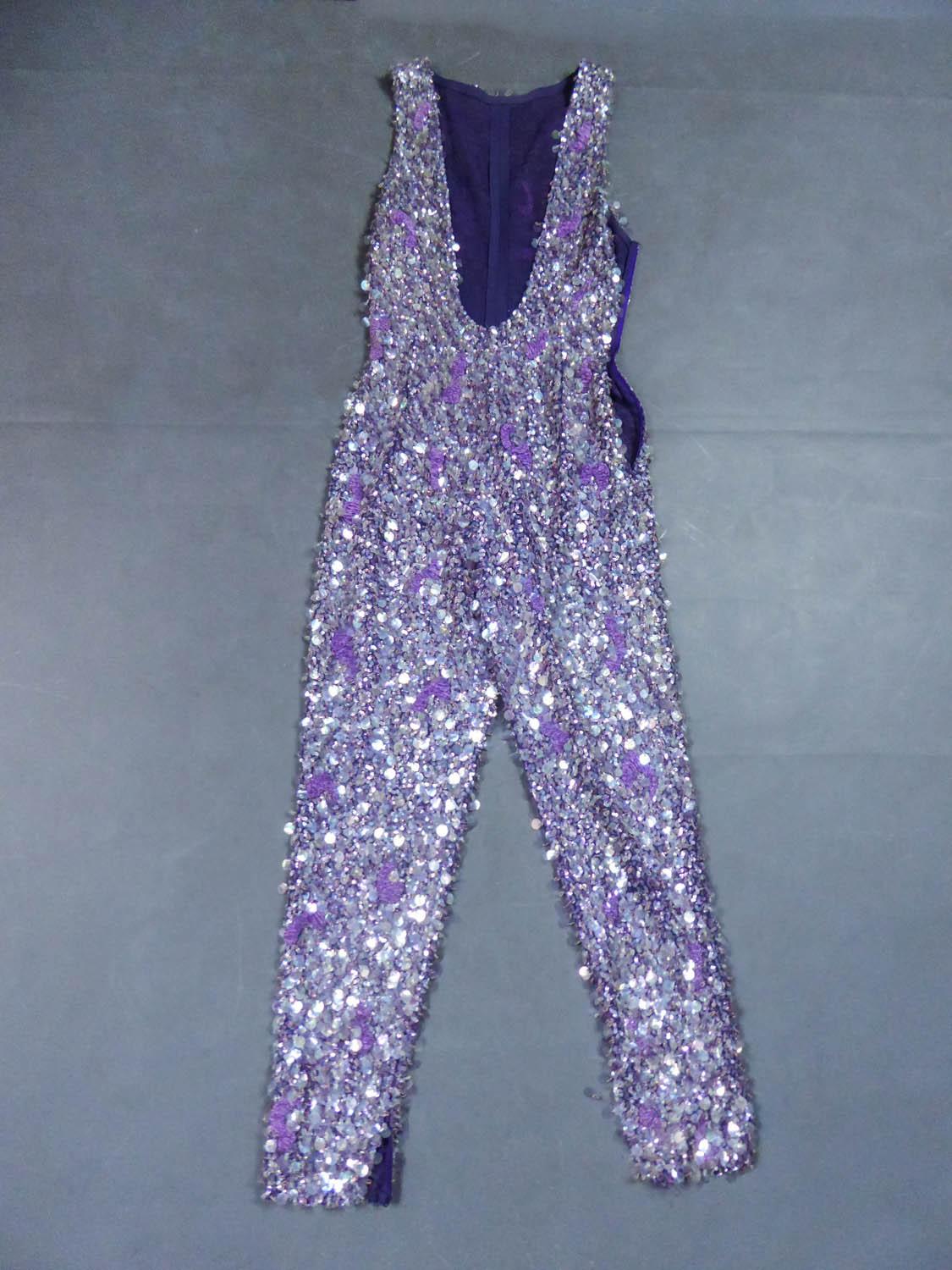 Circa 1968/1970
Italy

Amazing psyquedelic trousers suit from the famous Italian designer house Mila Schön from the 1970s. Entirely hand-embroidered with iridescent glitter, rhodoid sequins and pearlescent and purple glass beads. Embroidery of