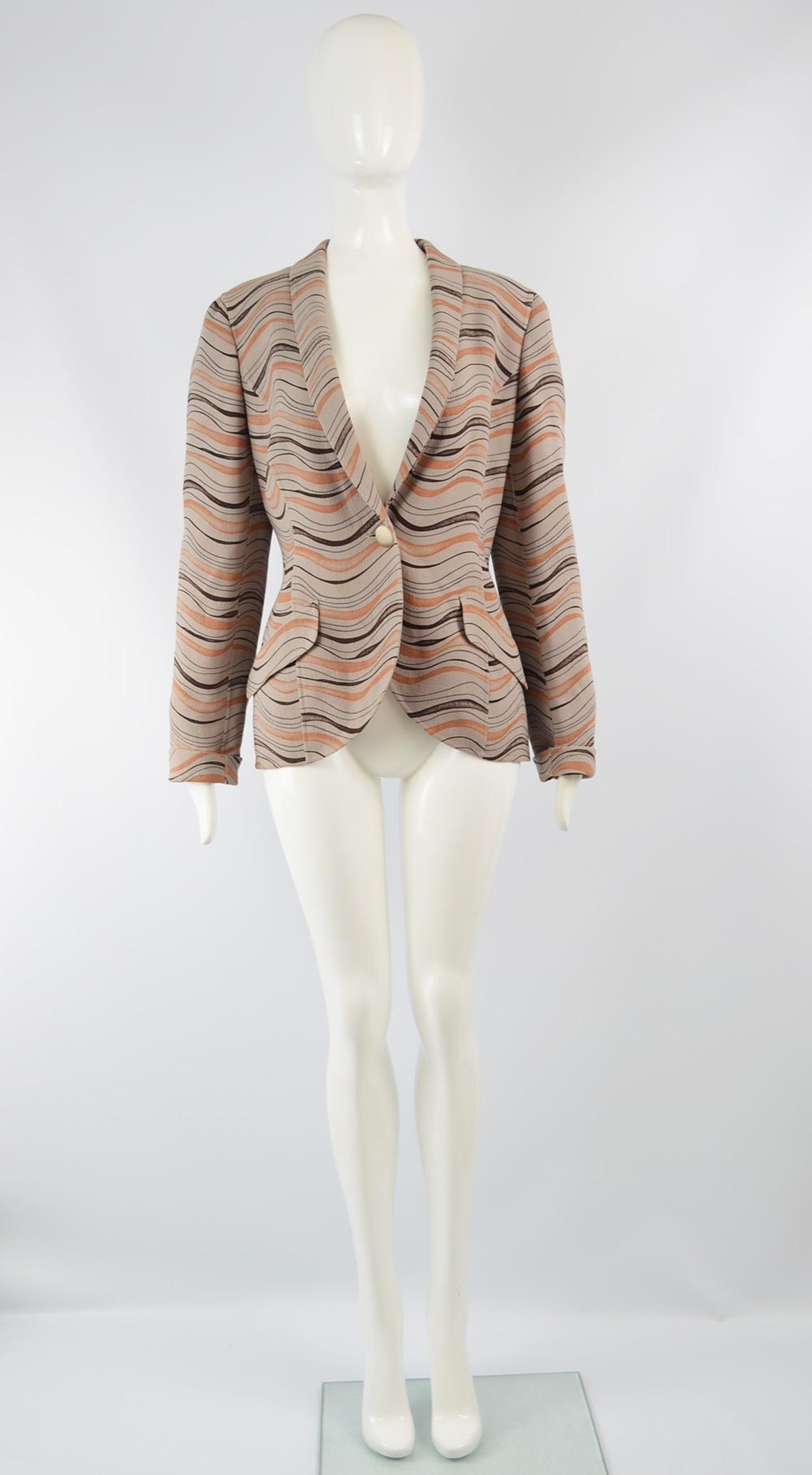 A chic vintage women's jacket from the 80s by luxury Italian fashion designer, Mila Schön. Made in Italy and beautifully tailored, it is made from a lightweight, taupe colored wool crepe with an orange and black wavy pattern. It fastens with a
