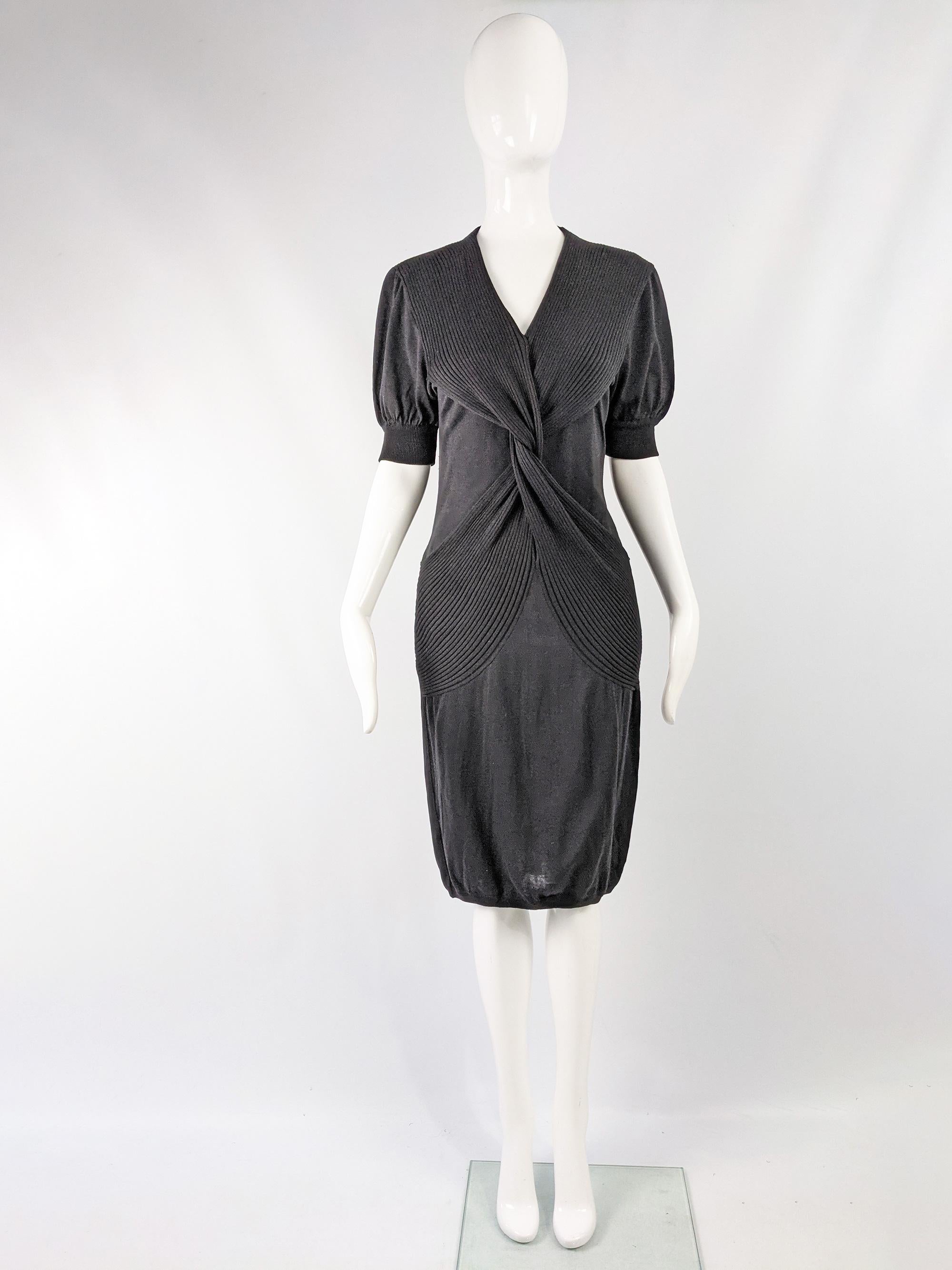 A beautiful vintage dress from the 80s by luxury Italian fashion designer, Mila Schon. Made in Italy, in a black lightweight cotton knit fabric with a twisted front and short puffed sleeves. Perfect for day or evening. 

Size: Marked S
Bust -