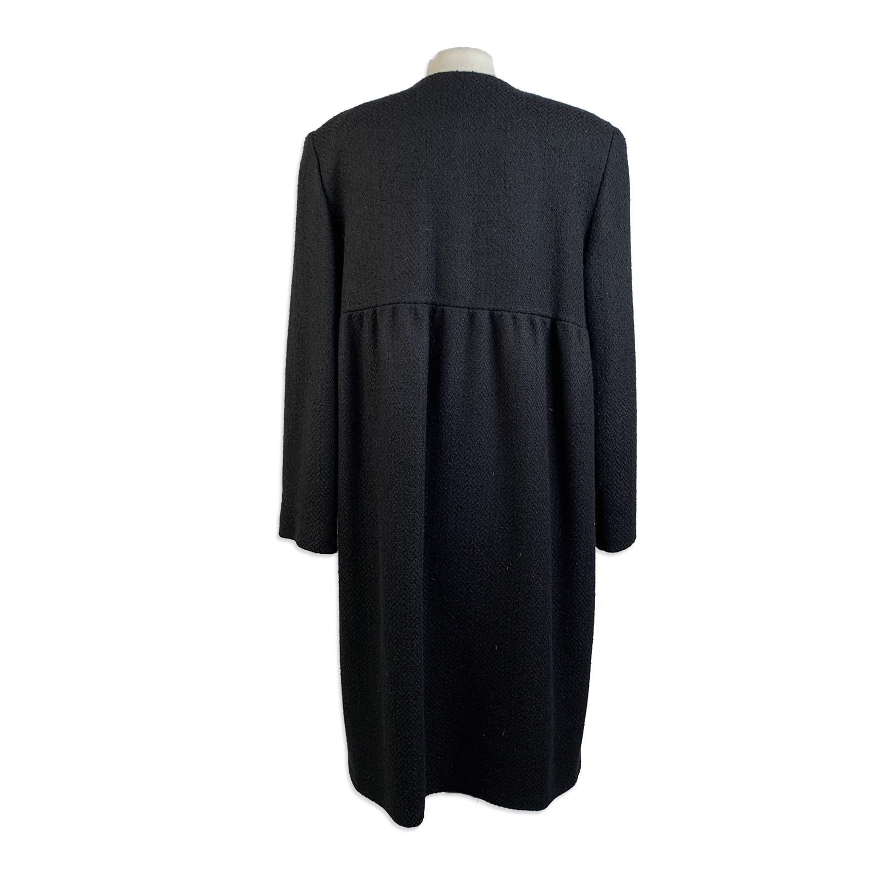 Mila Schon black wool blend coat with collarless design. It features and empire waistline, button closure on the front and 2 hips pockets. Composition:97% Wool, 3% Nylon. Satin lining. Made in Italy. Size: 42 IT (The size shown for this item is the