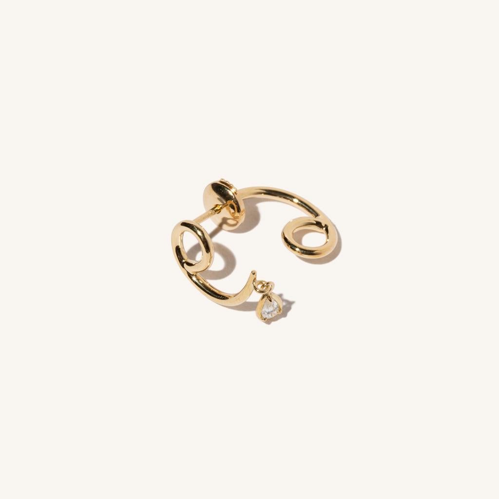 Zodiac inspired items are special items that have long been said to be auspicious. MILAMORE's zodiac motif earrings take form in 18 karat yellow gold accented with a single, sparkling diamond and finished in an abstract shape that looks good on