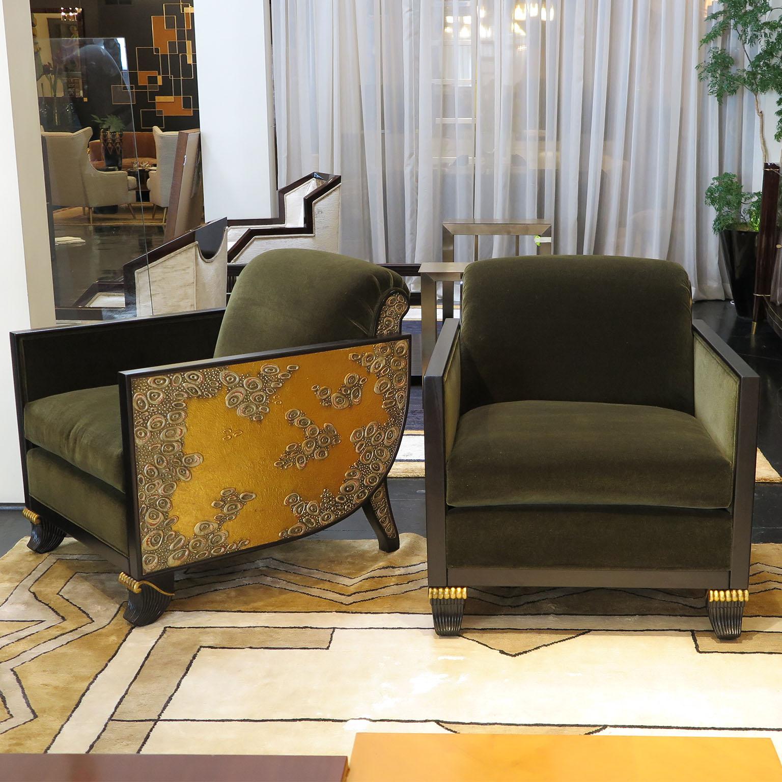 Pair of lounge chairs from Milan 1980s inspired by Jacques Emile Ruhlmann chairs with an added twist of carved relief arms in gold leaf reminiscent of a Gustav Klimt painting.
The thin wooden arms are in a dark brown stained Mahogany in a matte