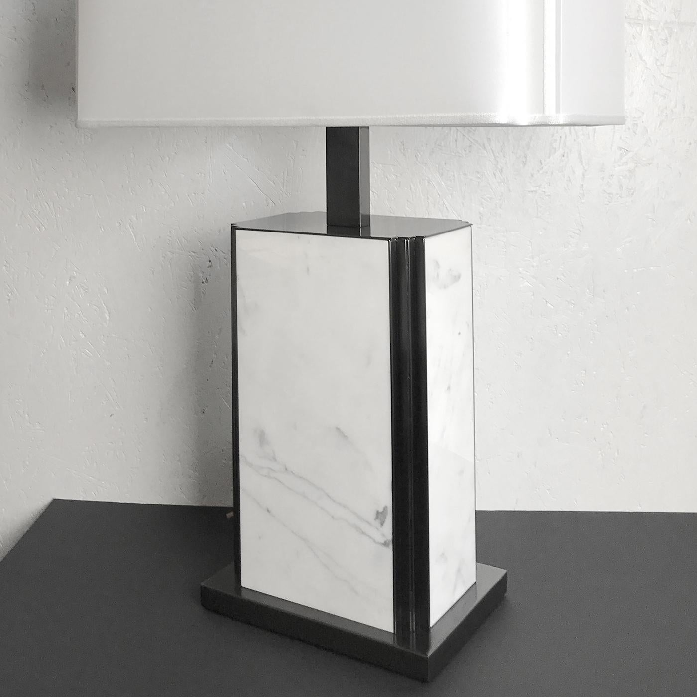 Perfect for the modern home where it will bring a sophisticated touch on any table or console, this table lamp exudes luxury with its sleek Carrara marble base and crisp fabric shade. Graphic and bold, this statement-making table lamp's angular