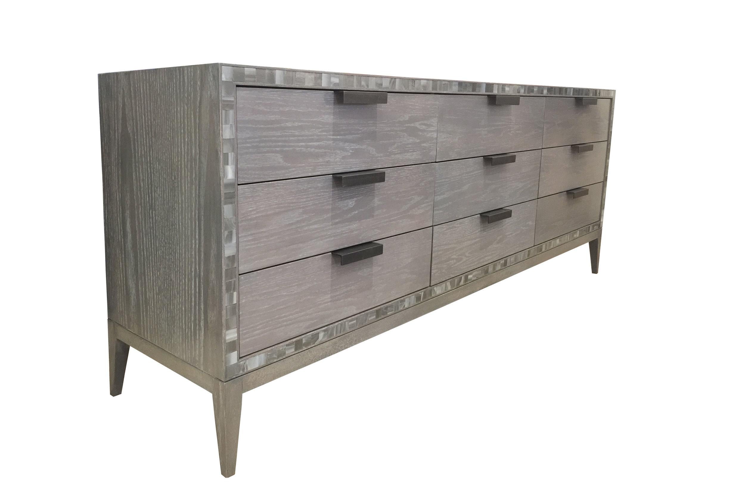 The Milano chest of 9 drawers by Ercole Home consisted of 9 drawers all adorned with handmade industrial steel pulls. The chest its self is painted in our personal Earl Gray Ceruse Finish that compliments the natural grain of the oak wood. The
