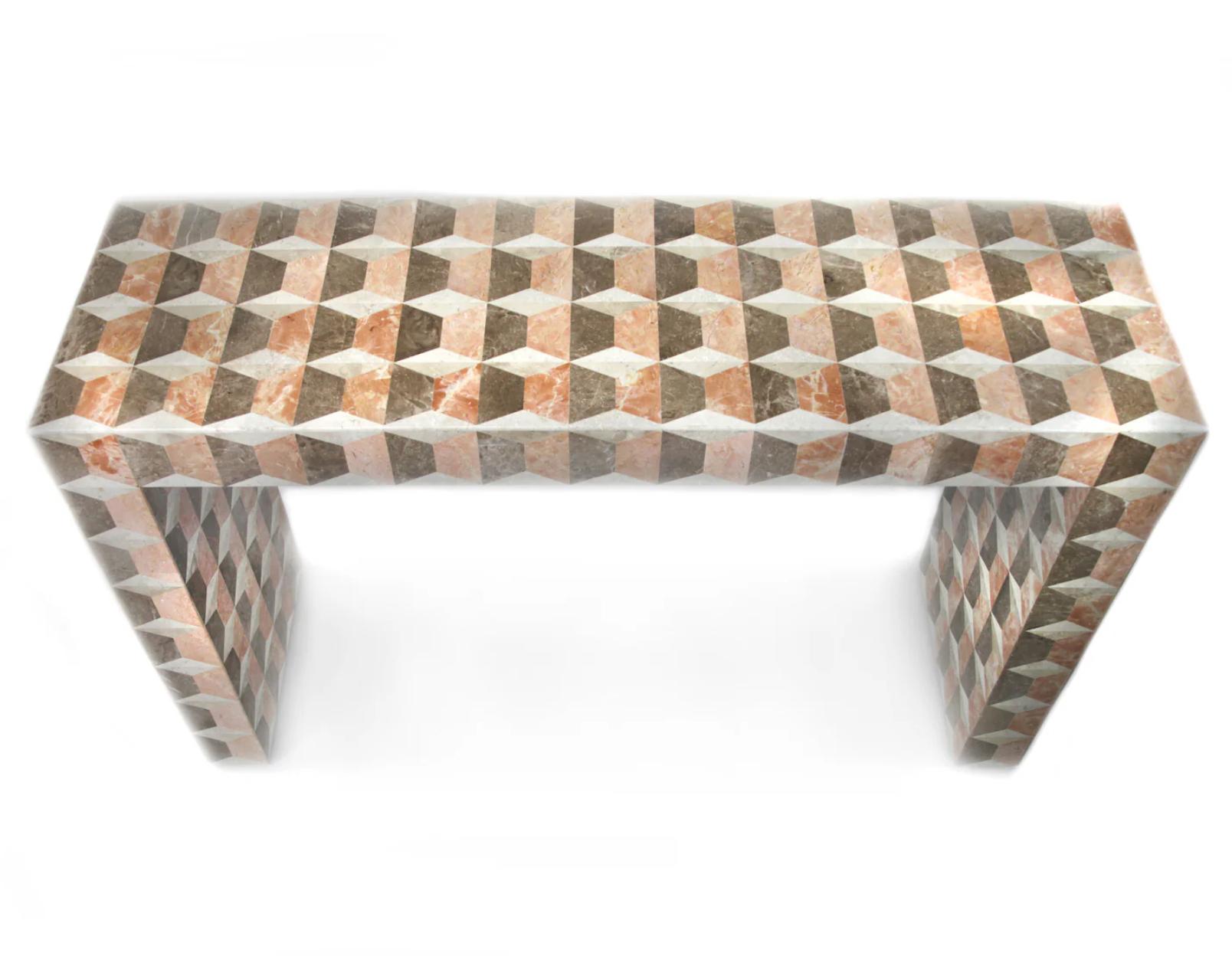 Inspired by the marvelous patterns of Fornasetti, the Milano console table is a bold accent piece for any setting. Using Fossil stones and Rose Marble craftsmen in the Philippines meticulously inlaid the natural materials in a geometric pattern.