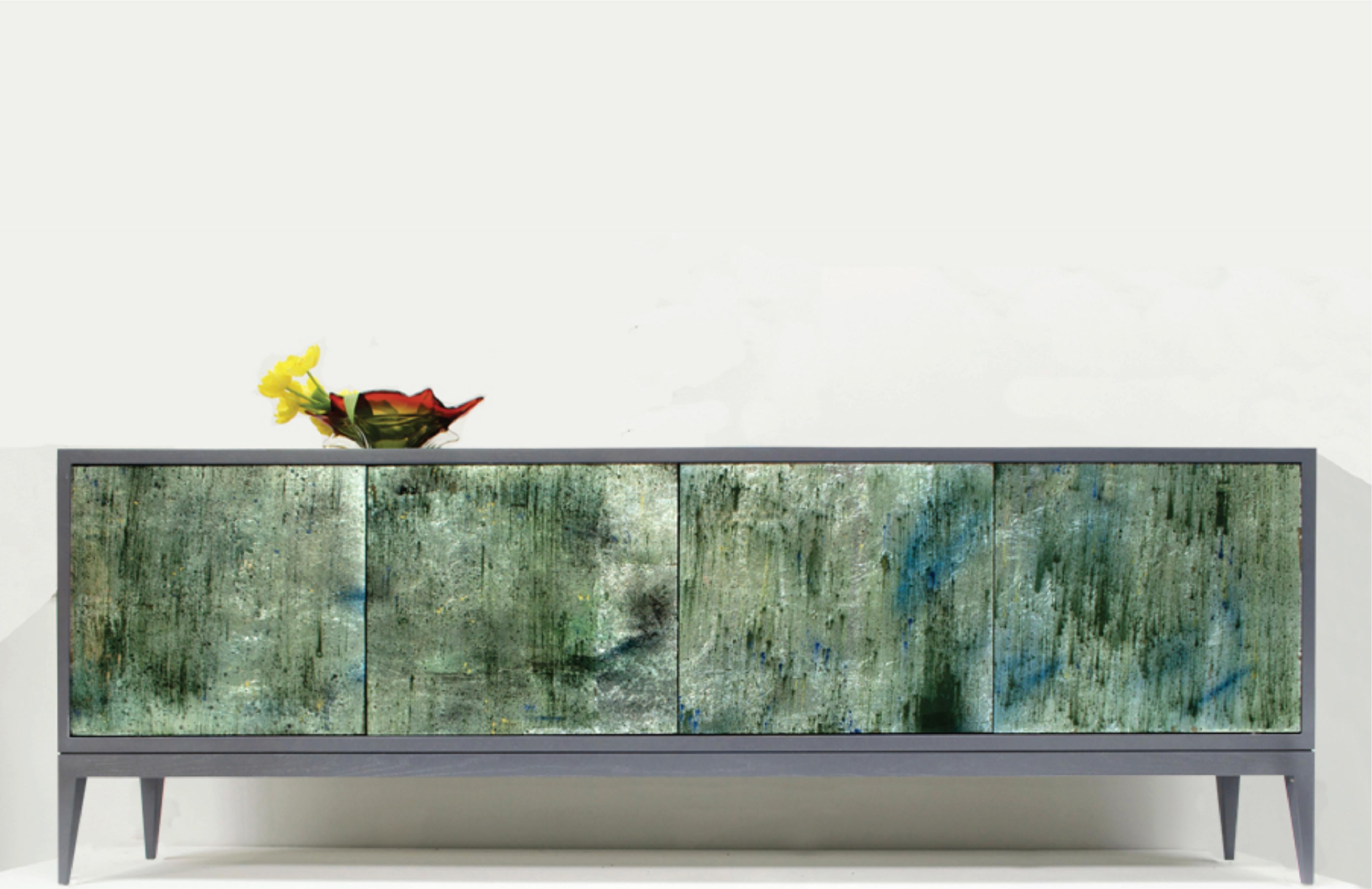 The Milano buffet by Ercole Home has a 4-door touch latch on the front front, with reversed painted glass in moss greens and blues and a painted gray wood finish on oak. 
Adjustable interior shelving on each compartment.
custom sizes and colors