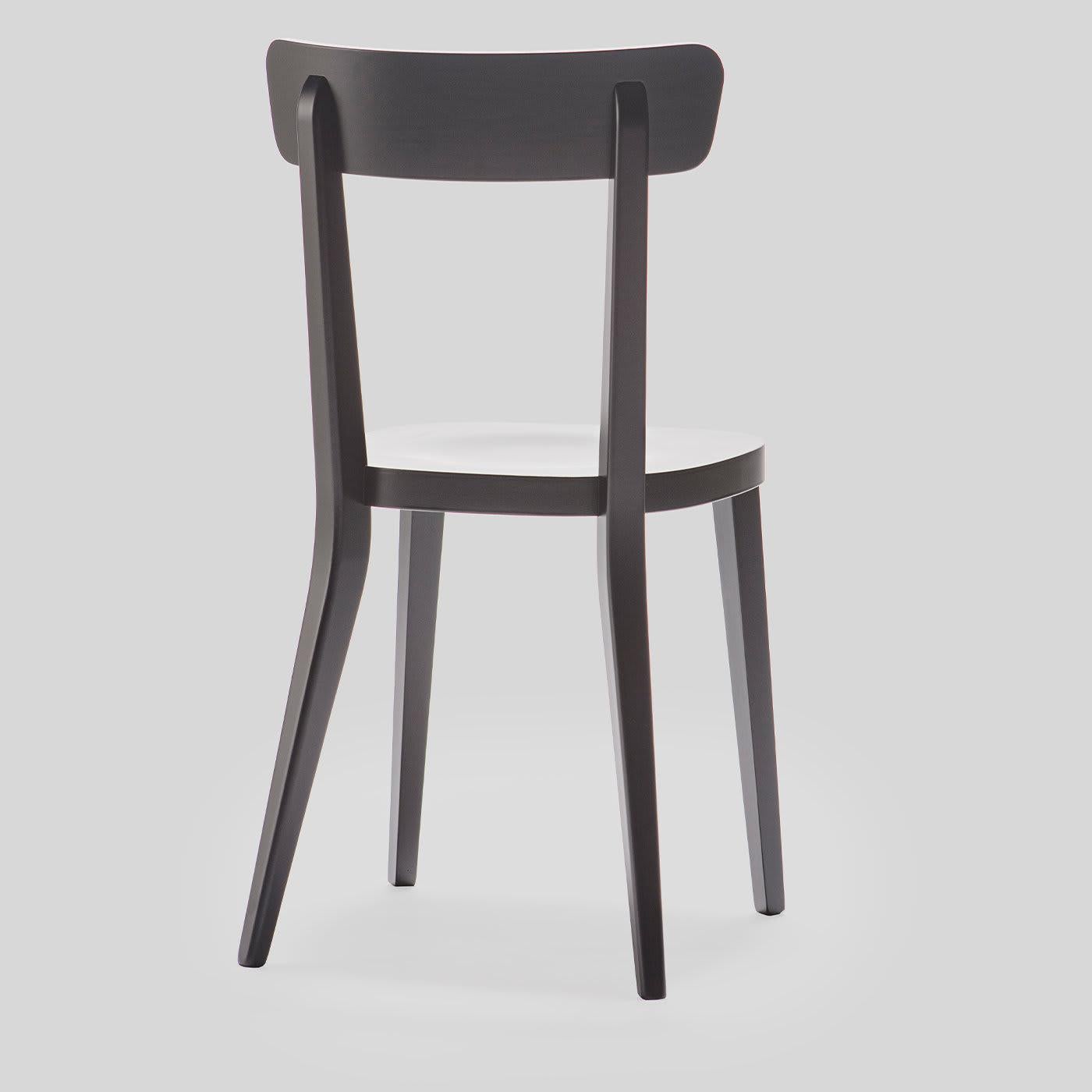 Restyled from the original 1960 Milano Collection, this new version boasts a gently curved backrest and back legs, all in solid beechwood finished in a dramatic black color. This versatile chair is suitable for a variety of residential and