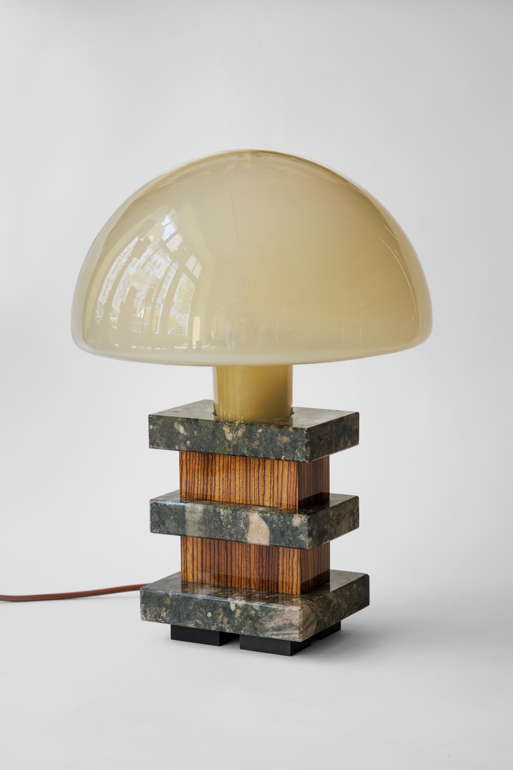 TABLE LAMP MILANO - Limited Borsani Edition 1/7 - No. 7

The new table lamp MILANO by Fabian Freytag Studio is a fascinating example of how artificial intelligence and traditional craftsmanship can harmoniously collaborate. The design of the lamp