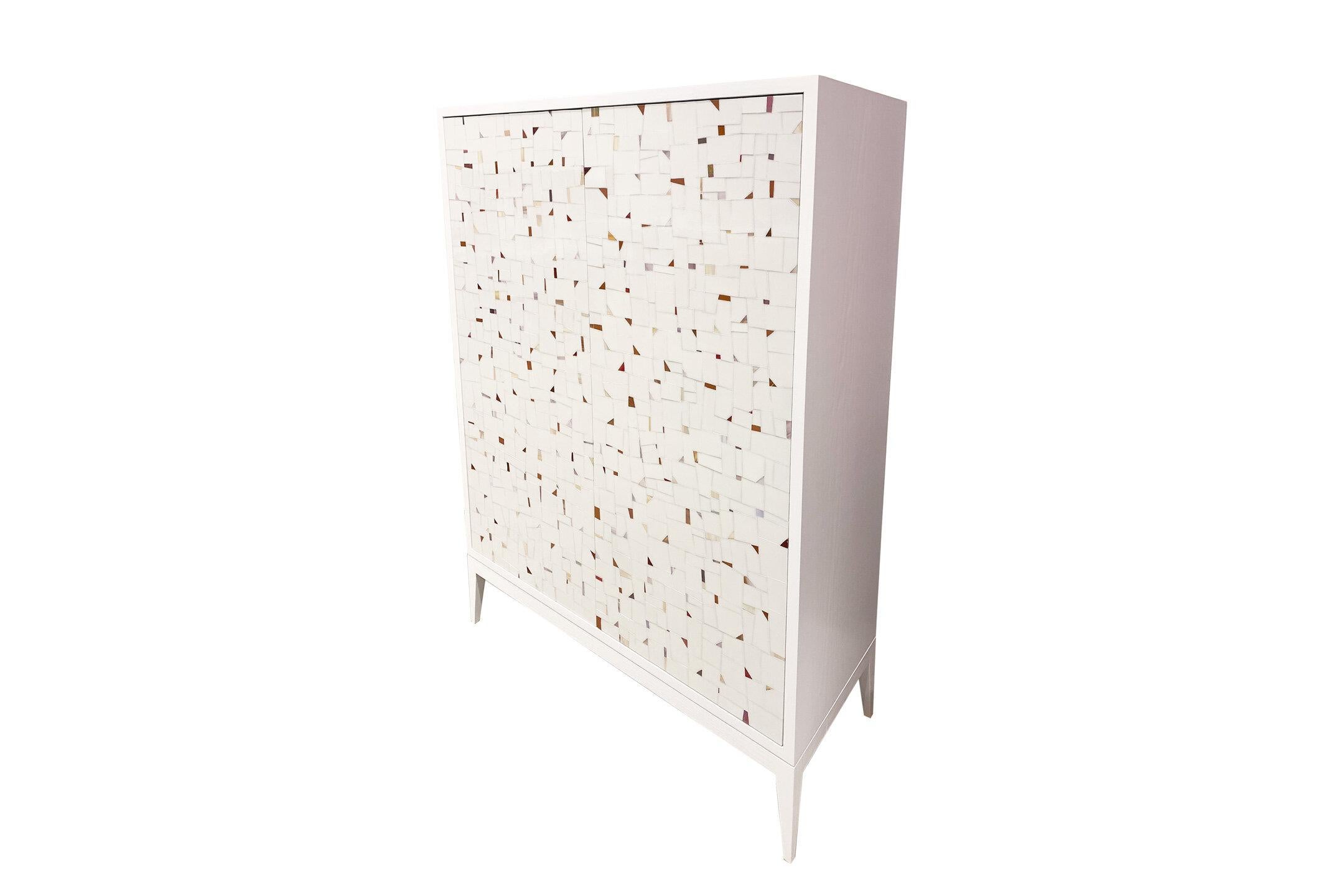 The Milano Terrazzo 2-door bar cabinet by Ercole Home is a 2 door touch latch bar cabinet that is outfitted with two pull out drawers, four interior shelves for storage space, and a wine glass holding rack on top. Perfect for anyone who loves