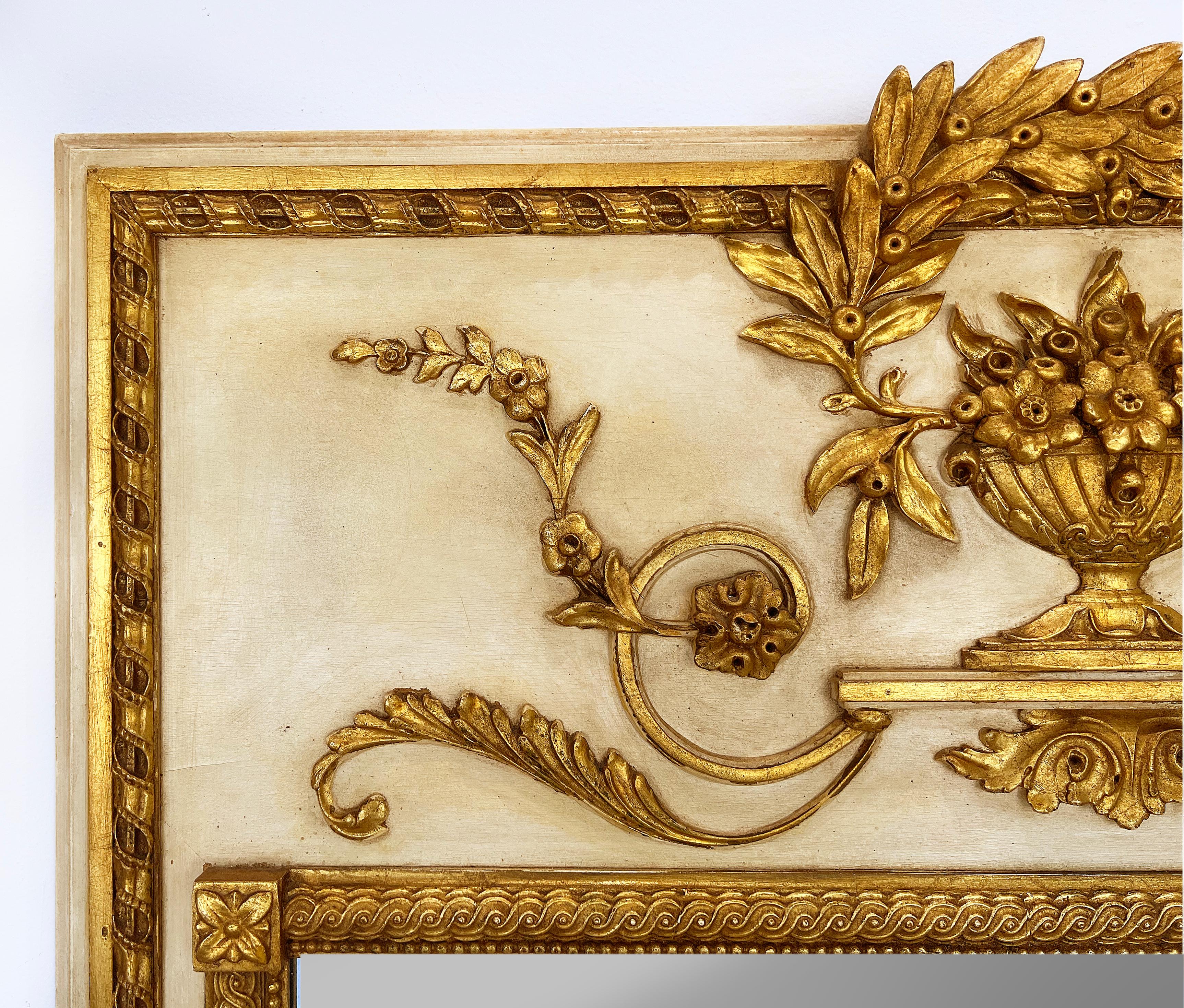 1960s Neoclassical giltwood trumeau style Milch & Son Italian painted mirror.

Offered for sale is an elegant Neoclassical style painted and carved giltwood mirror by Milch & Son of Italy. The wood frame has carved giltwood foliage cartouche