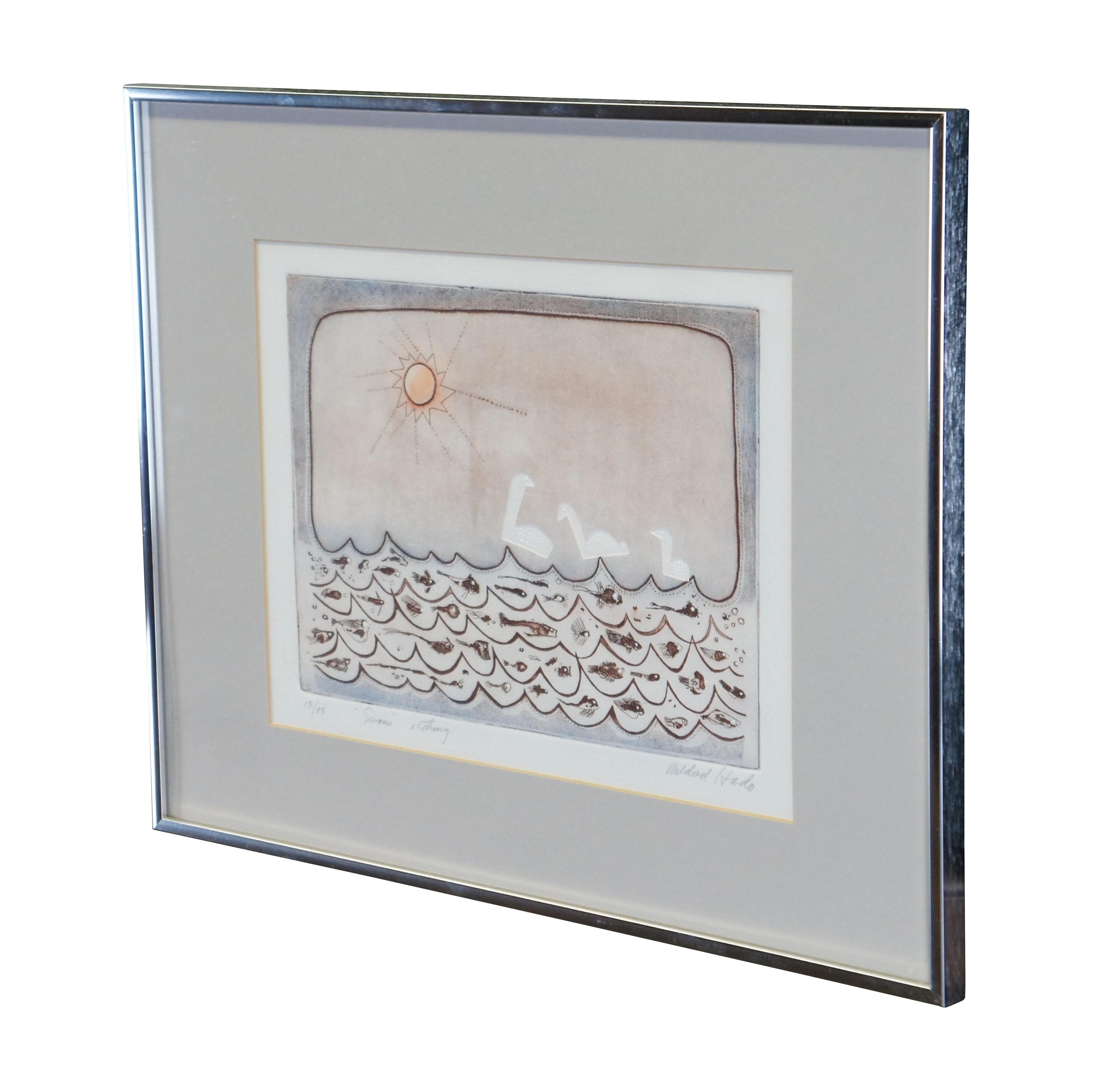 Vintage Mildred Hado etching titled Swans, circa 1970s.  It features a nautical abstract seascape theme with three swans under the sun and a below water view of subterranean ocean depths with deep sea creatures / fish.

Dimensions:
20
