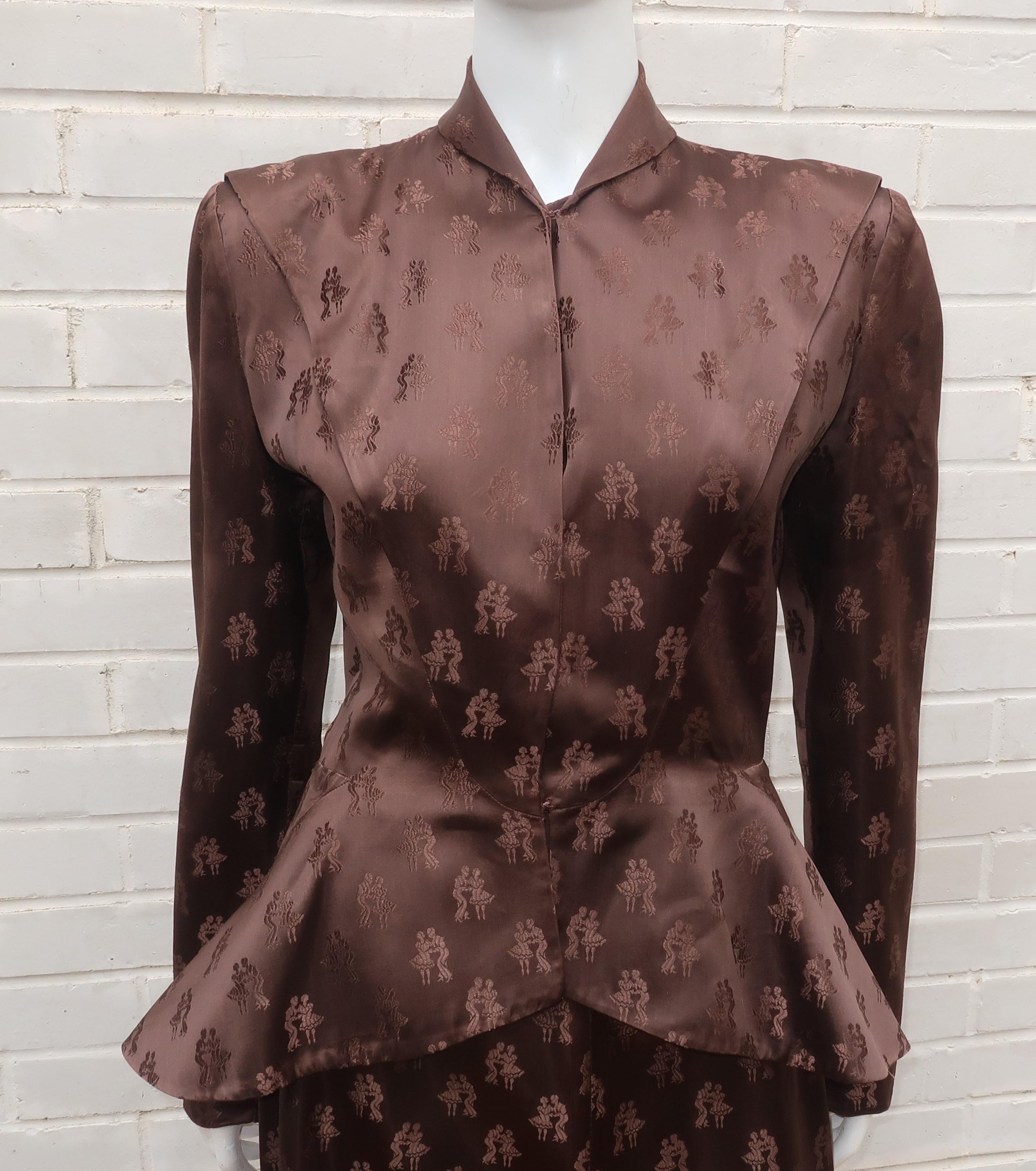 1940's Mildred O'Quinn brown satin jacquard skirt suit with a fun fabric depicting swing dancers.  The classic '40's silhouette includes a peplum shaped jacket with defined shoulders and a modified a-line skirt.  The jacket has hidden hook closures