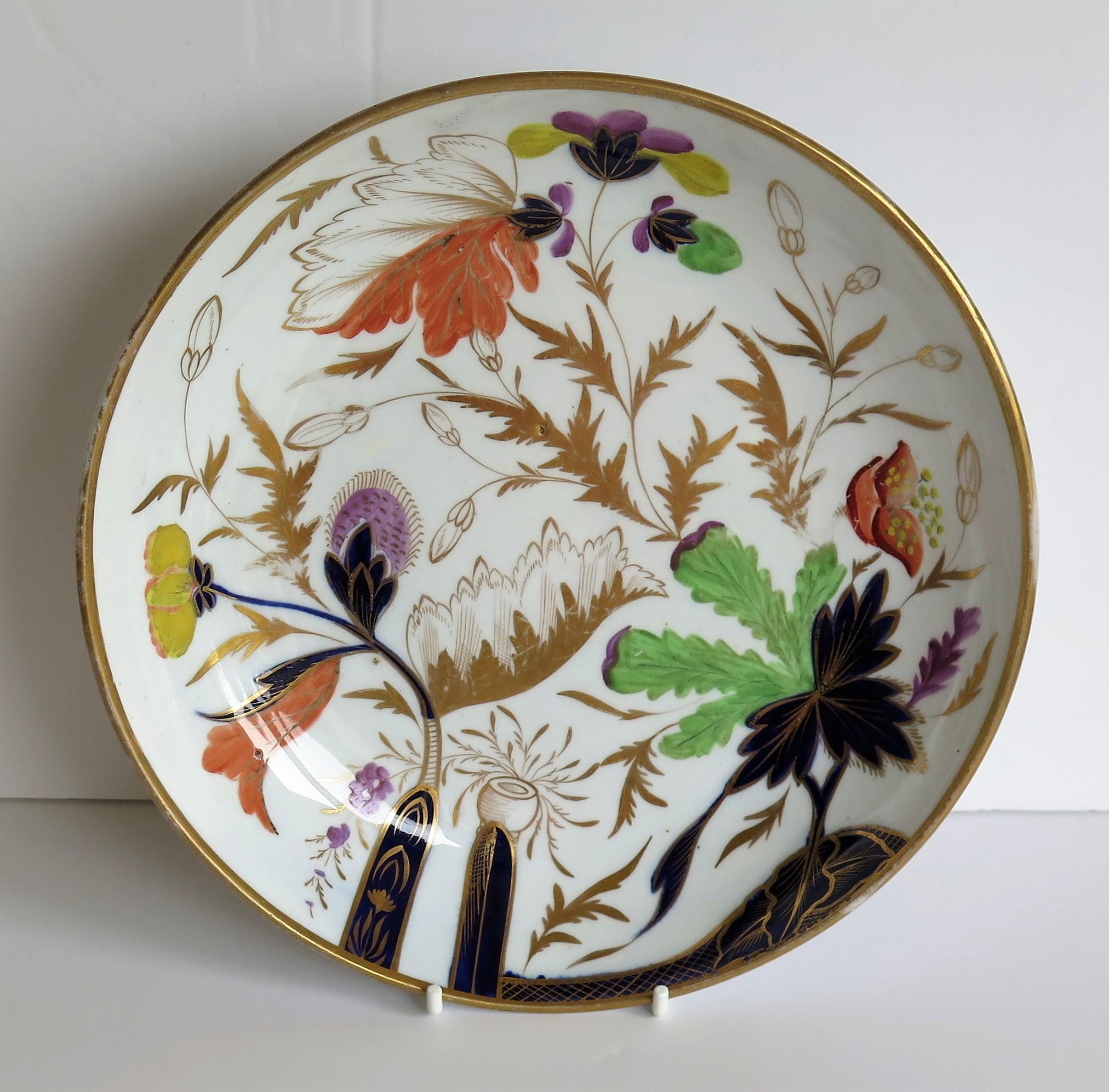 This is a porcelain, hand painted and gilded deep plate or saucer dish made by Miles Mason (Mason's), Staffordshire Potteries, England in the very early years of the 18th century, George III period, circa 1805-1808.

The dish is well potted on a